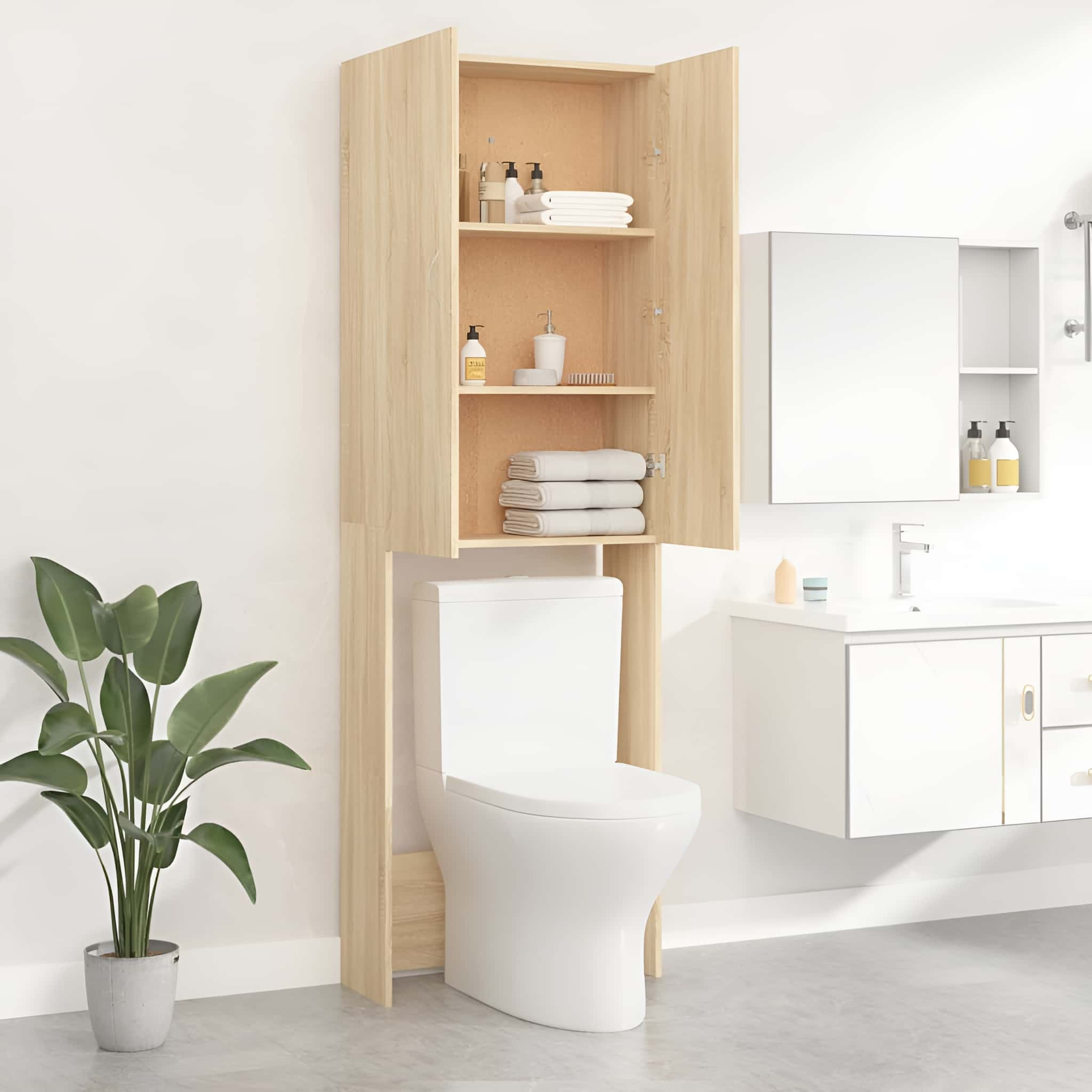 Badezimmerschrank über einer Toilette, mit Regalen für Toilettenartikel. Eine Pflanze und ein Spiegel sind ebenfalls zu sehen.