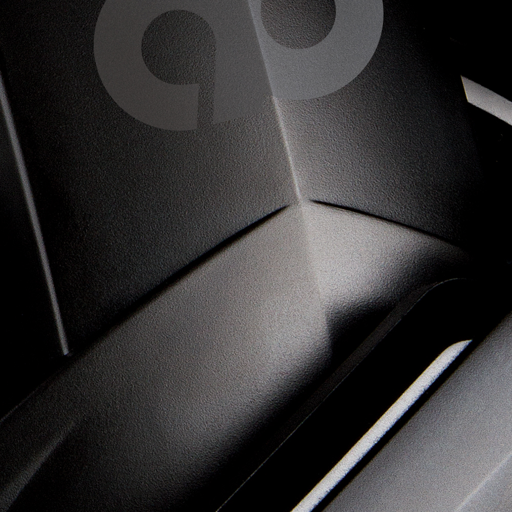 Close-up van een zwarte textuur met een subtiel patroon en highlights.