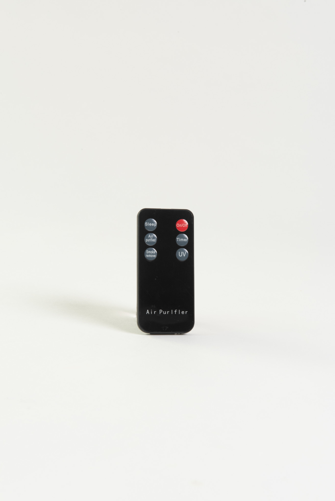 Telecomando nero con pulsanti per sleep, timer e luce UV.