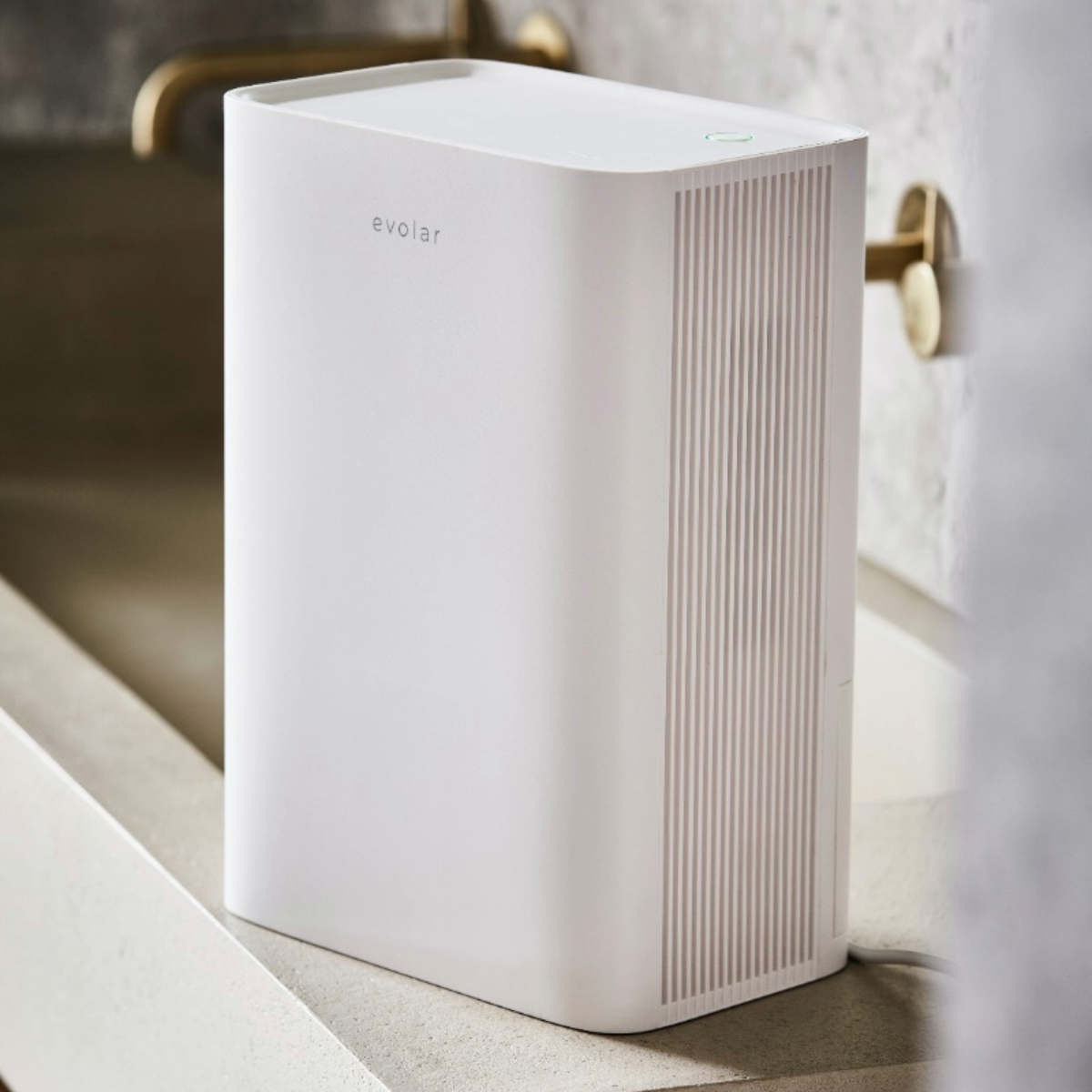 White air purifier in a bathroom setting.