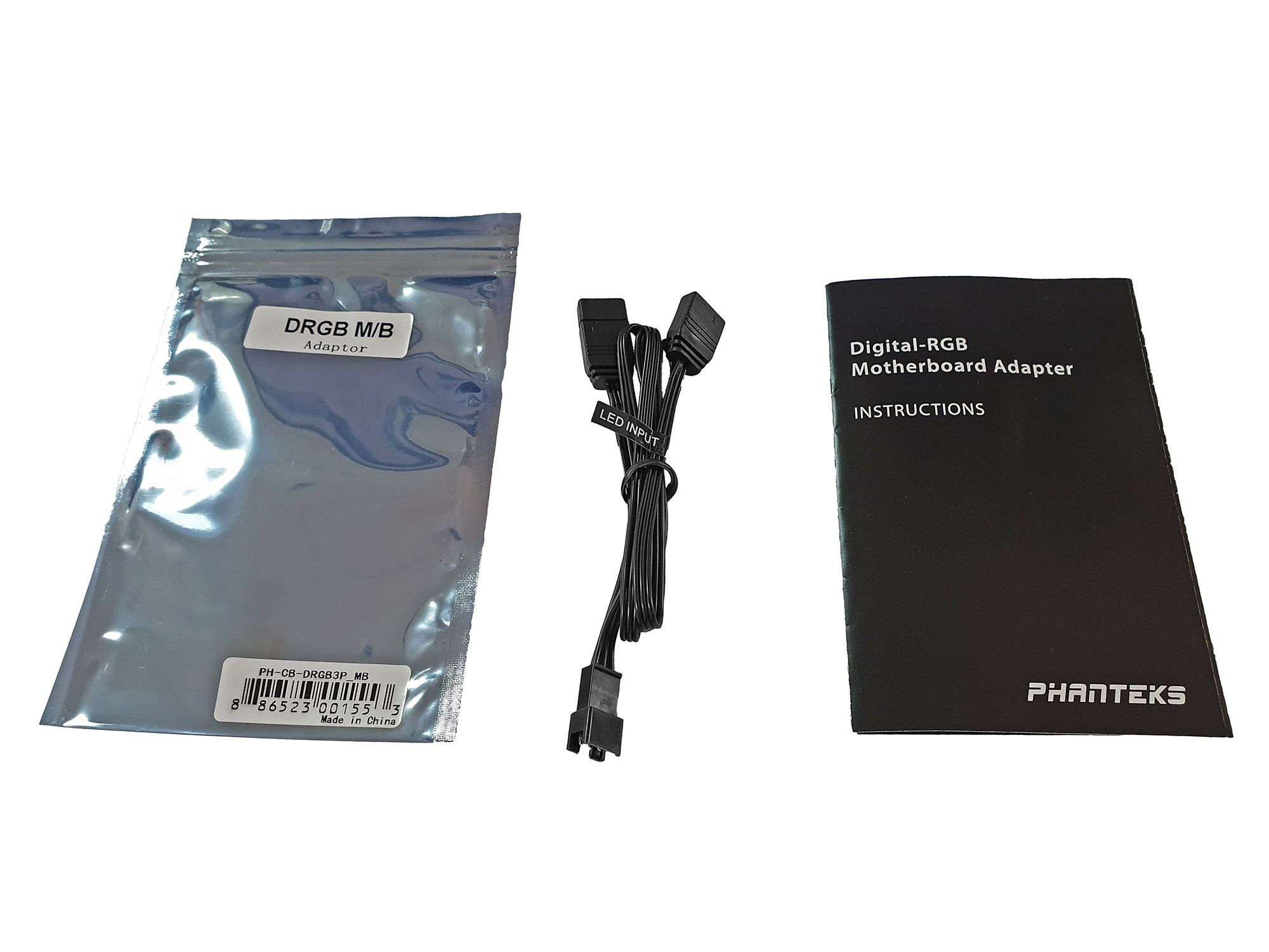 Busta, cavo e istruzioni. Busta nera con scritto DRGB M/B Adapter.
