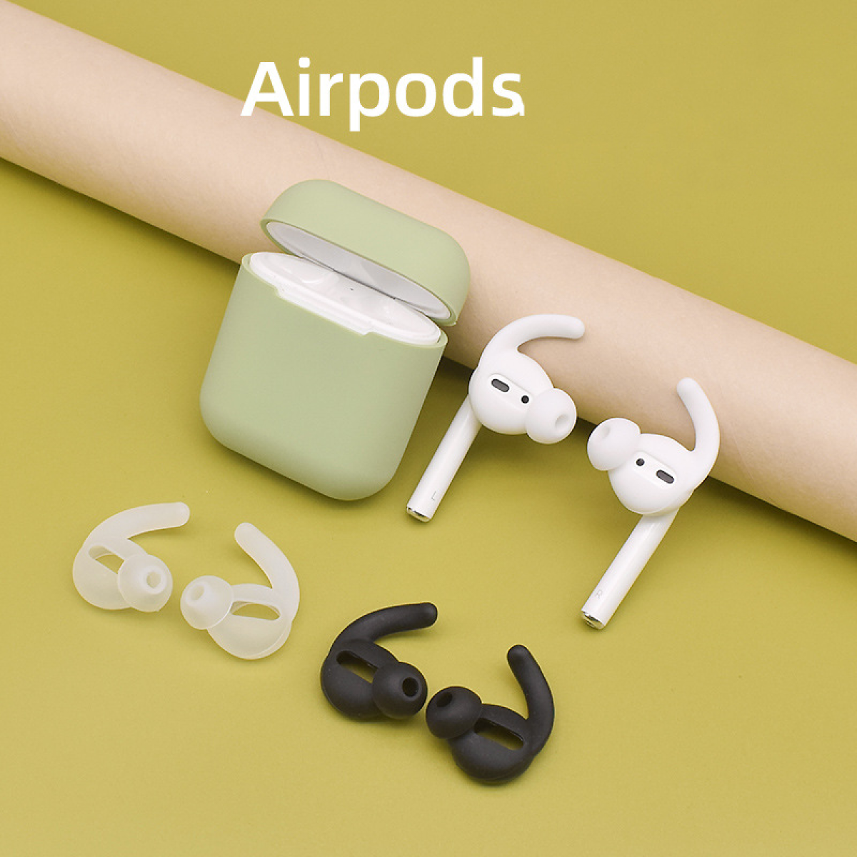 AirPods z wkładkami dousznymi i etui ładującym. Białe słuchawki, czarne i białe końcówki widoczne.