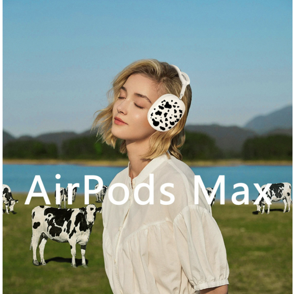 Eine Frau mit AirPods Max-Kopfhörern auf einer Wiese mit Kühen im Hintergrund.