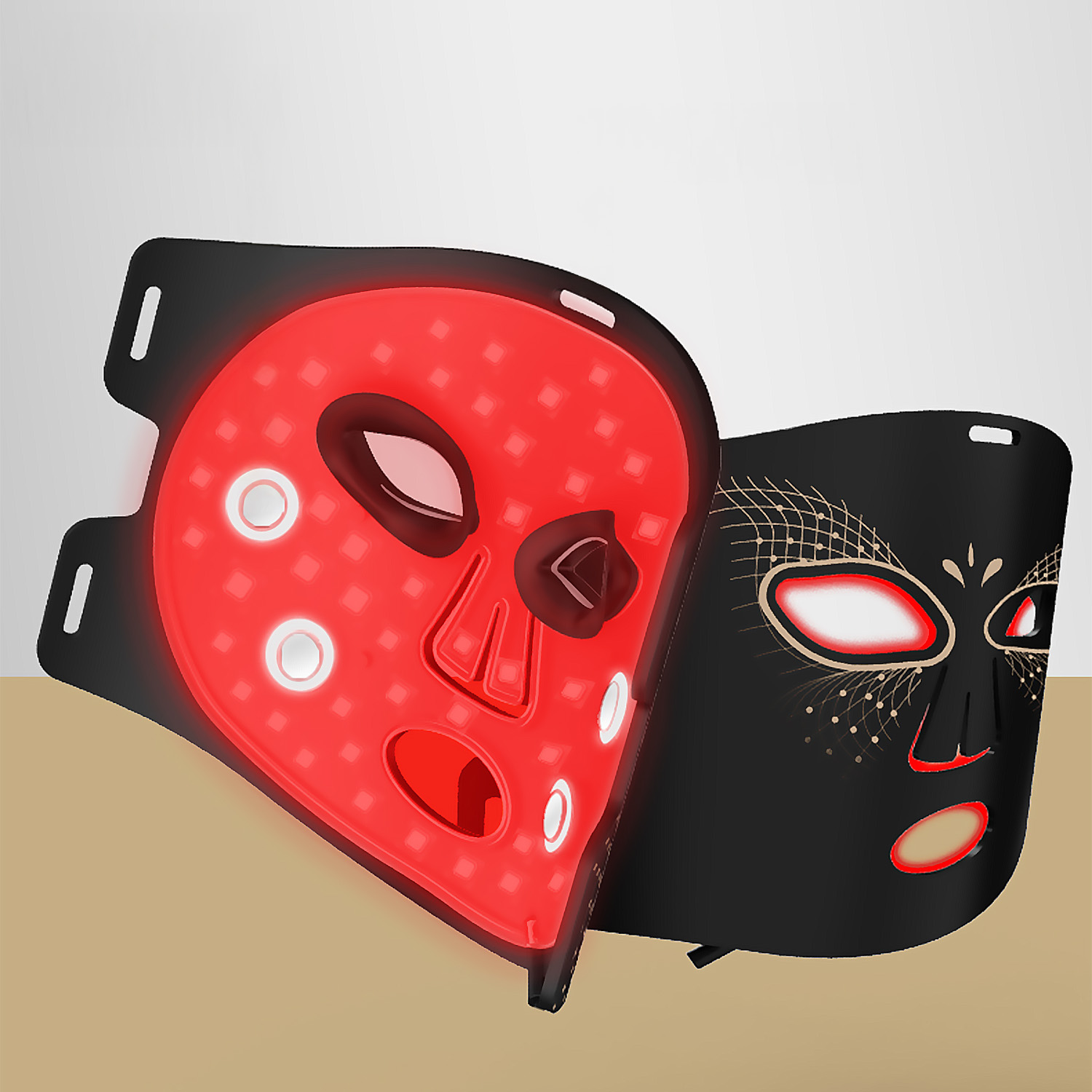 Zwei LED-Gesichtsmasken. Eine rot, eine schwarz mit goldenem Design. Beide haben Augen-, Nasen- und Mundaussparungen.