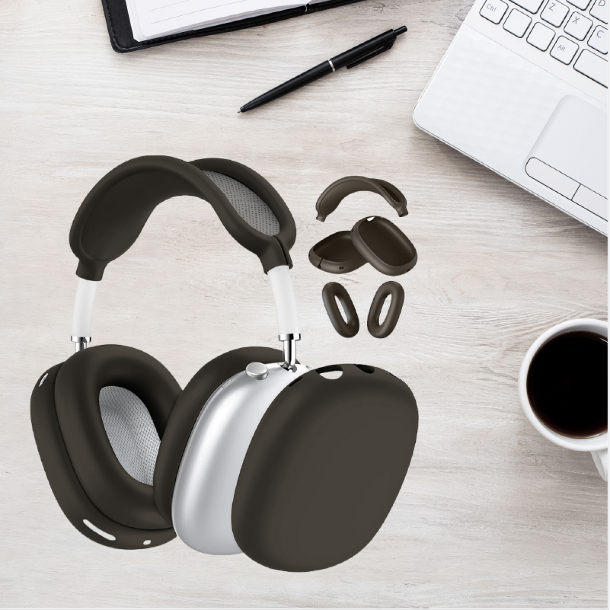 Auriculares con accesorios sobre una mesa de madera. Un cuaderno y una taza de café son visibles.
