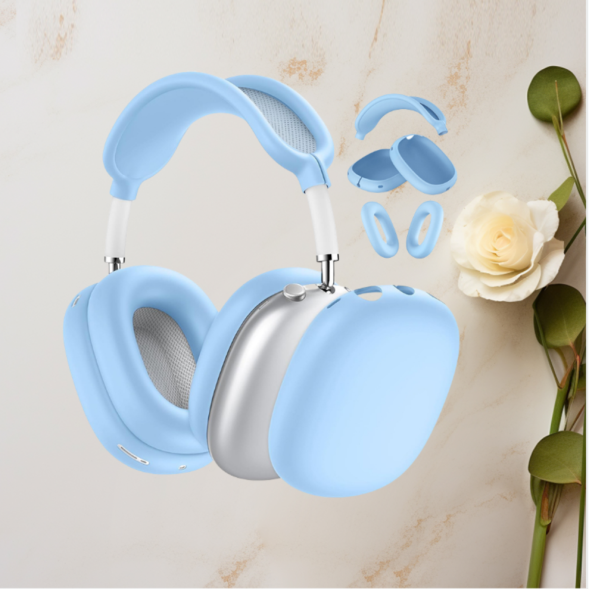 Auriculares azules con cubiertas para los oídos, cubiertas y accesorios adicionales, junto a una rosa blanca y hojas.