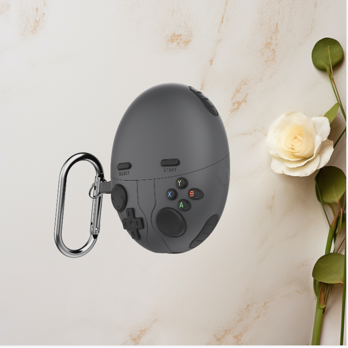 Una custodia grigia per controller di gioco con pulsanti, un moschettone argentato e un fiore su uno sfondo chiaro.