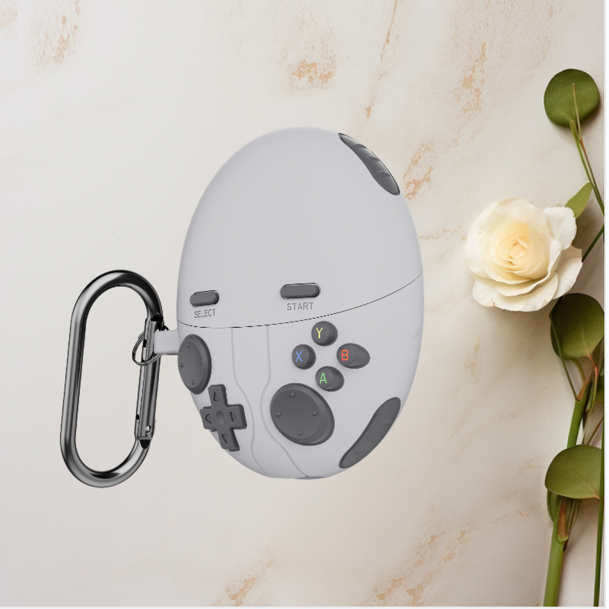 Controller bianco e grigio a forma di uovo con pulsanti, moschettone in metallo e un fiore.