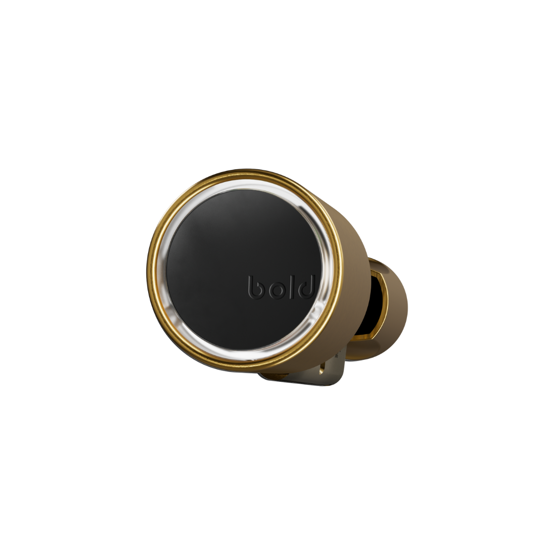 A small gold earbud with a black center, resting on a white background.