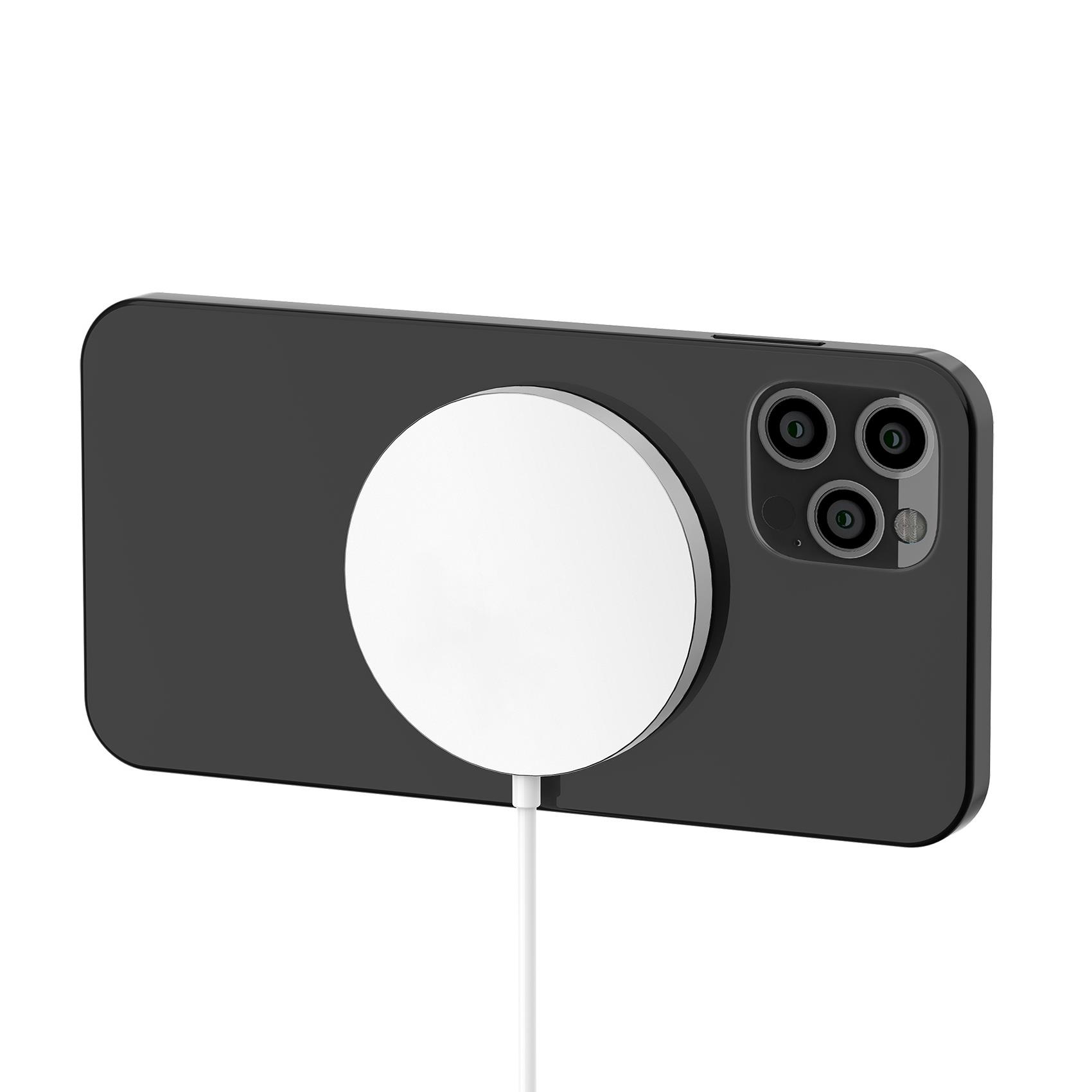 Un teléfono negro con un cargador circular blanco adjunto.