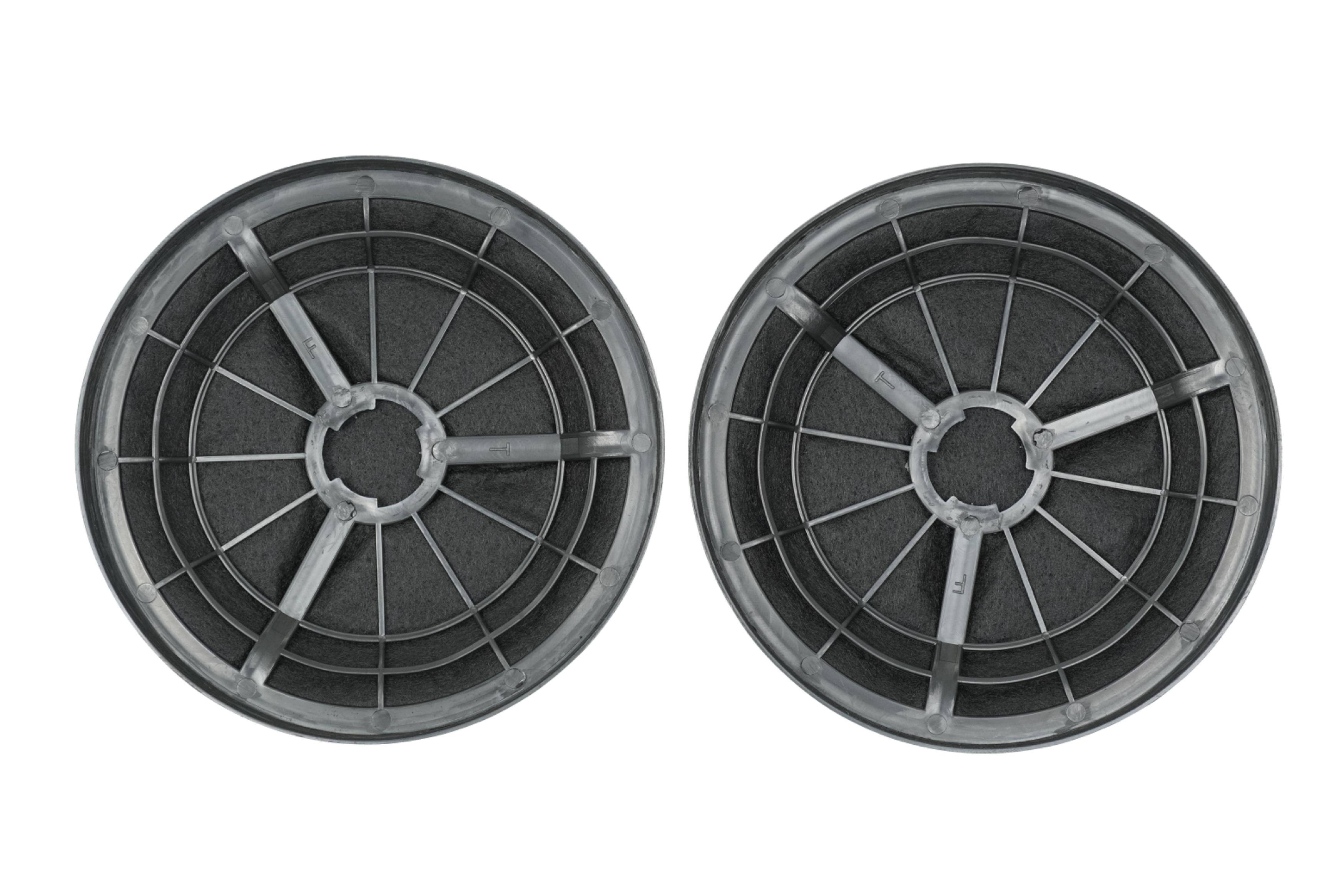 Two round, dark grey carbon filters, designed for an appliance, possibly a cooker hood.