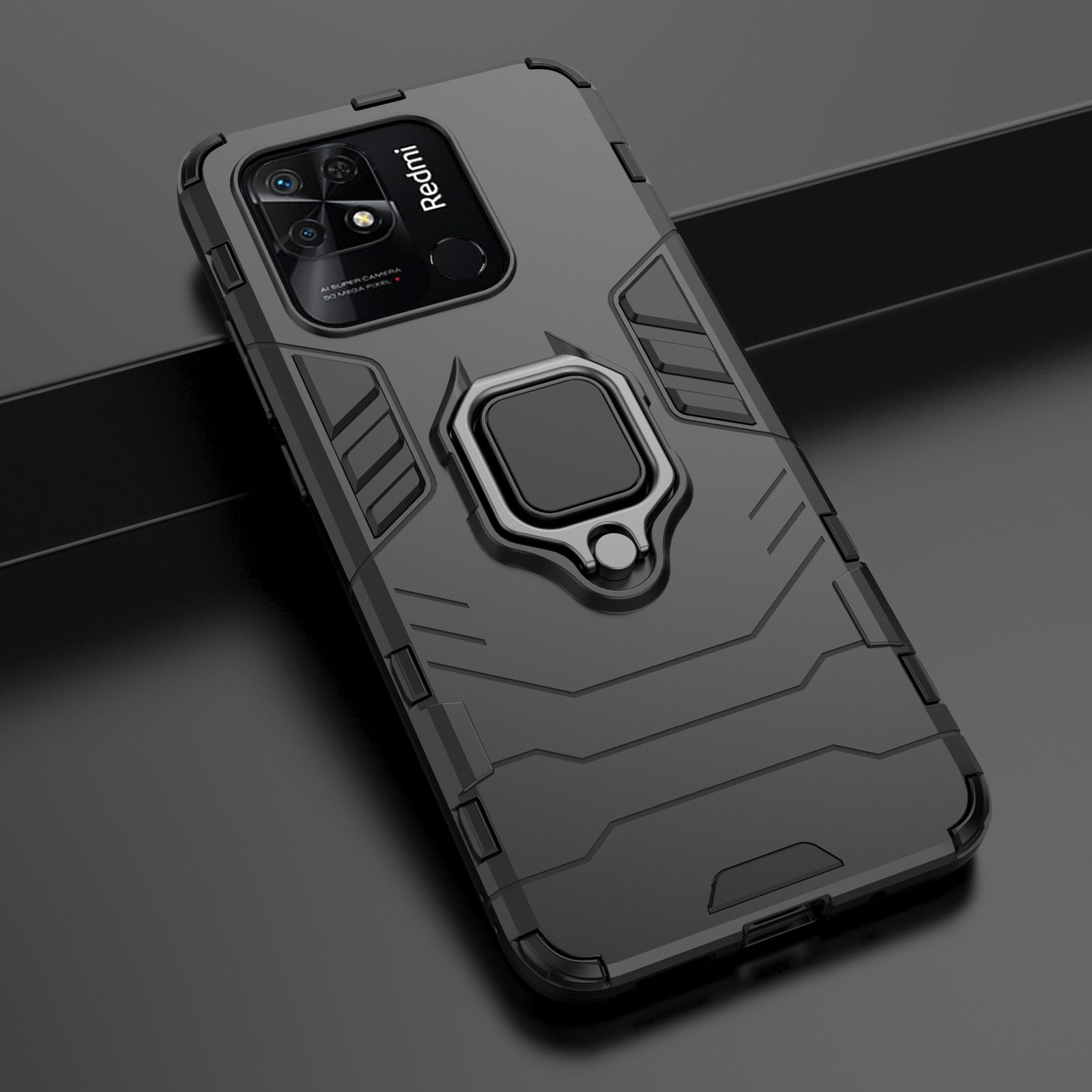 Funda negra para teléfono con soporte de anillo. La funda está sobre una superficie. El teléfono es Redmi.