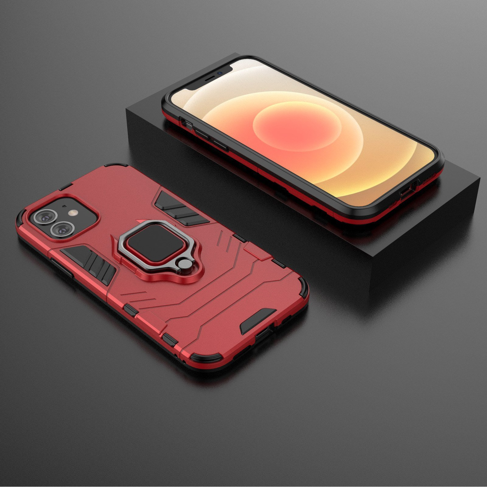 Funda roja con soporte de anillo y un teléfono al lado. El teléfono está sobre una superficie negra.