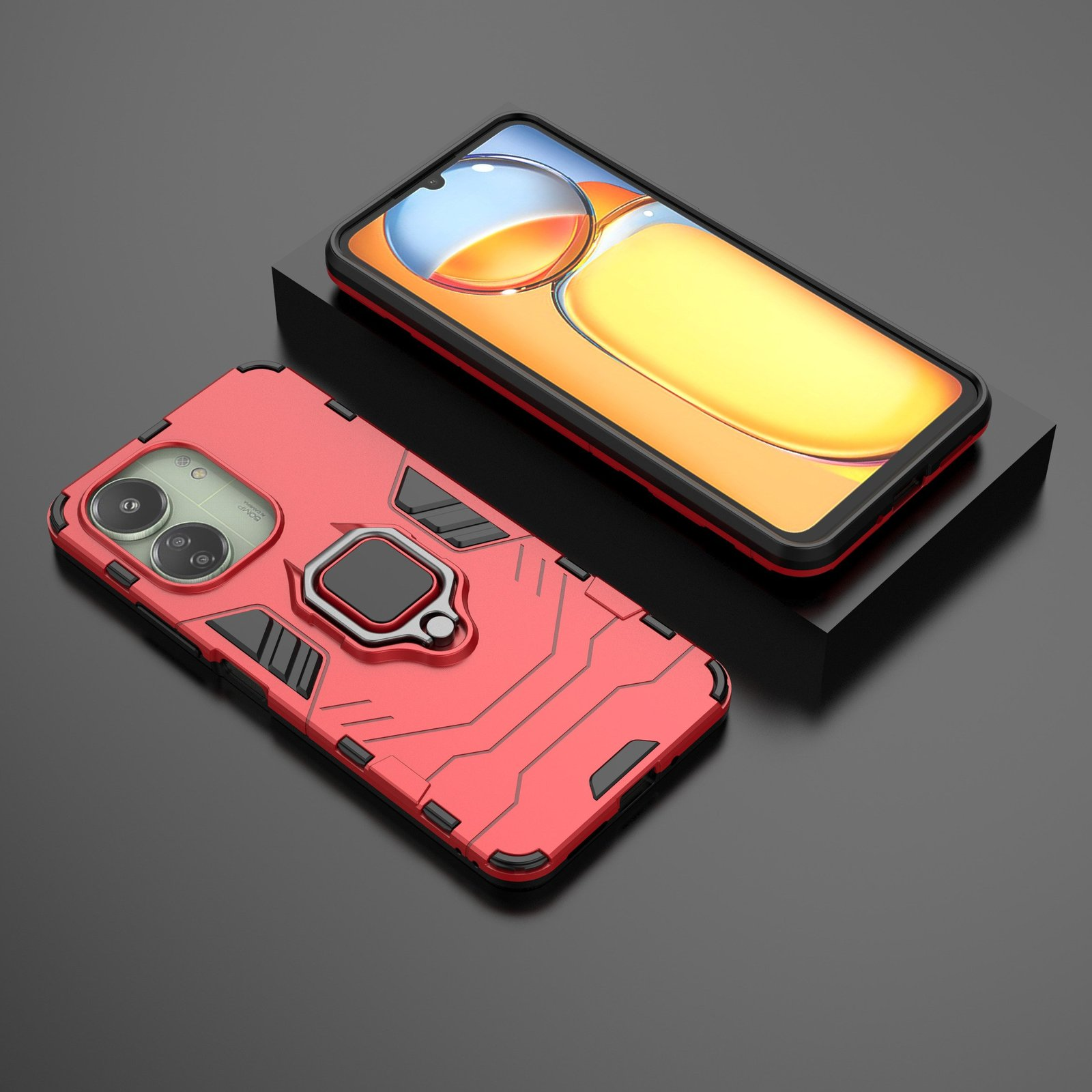 Funda de teléfono roja junto a un teléfono. La pantalla del teléfono es visible. La funda tiene un soporte de anillo.
