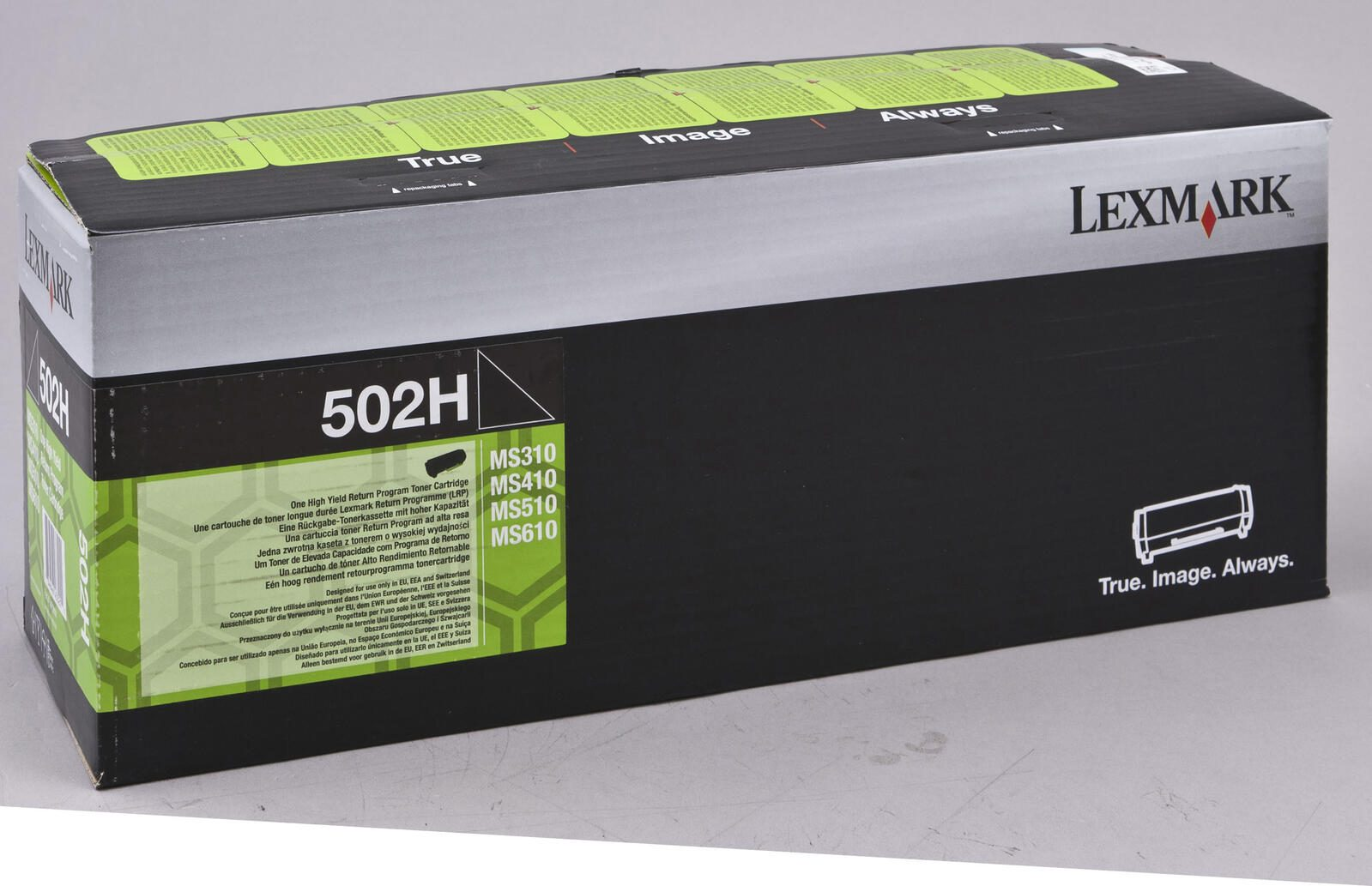 Een Lexmark 502H tonercartridge doos met groene en zwarte labels, op een lichtgrijze ondergrond.