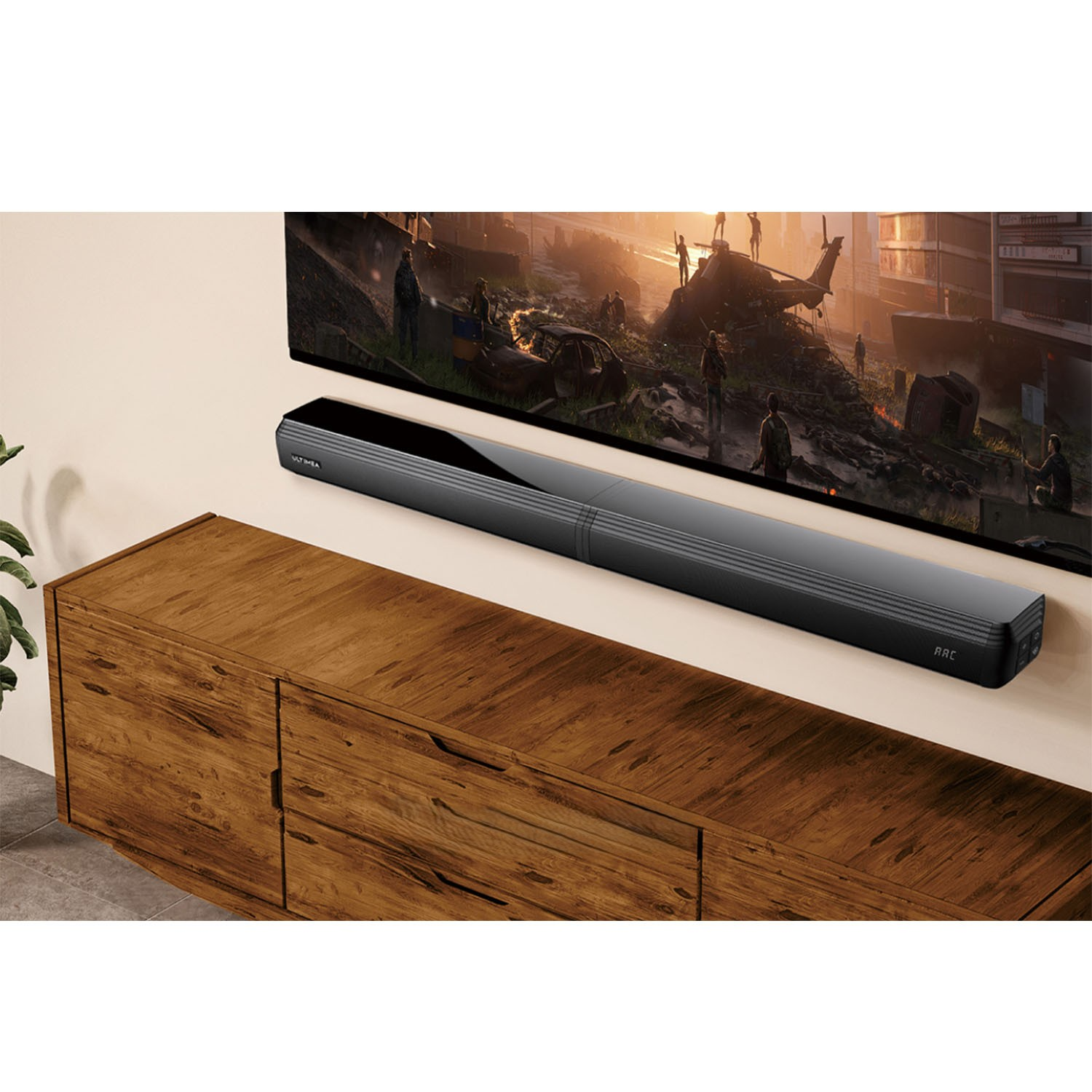 Barre de son noire fixée au mur sous une TV. La TV montre une scène avec un hélicoptère.