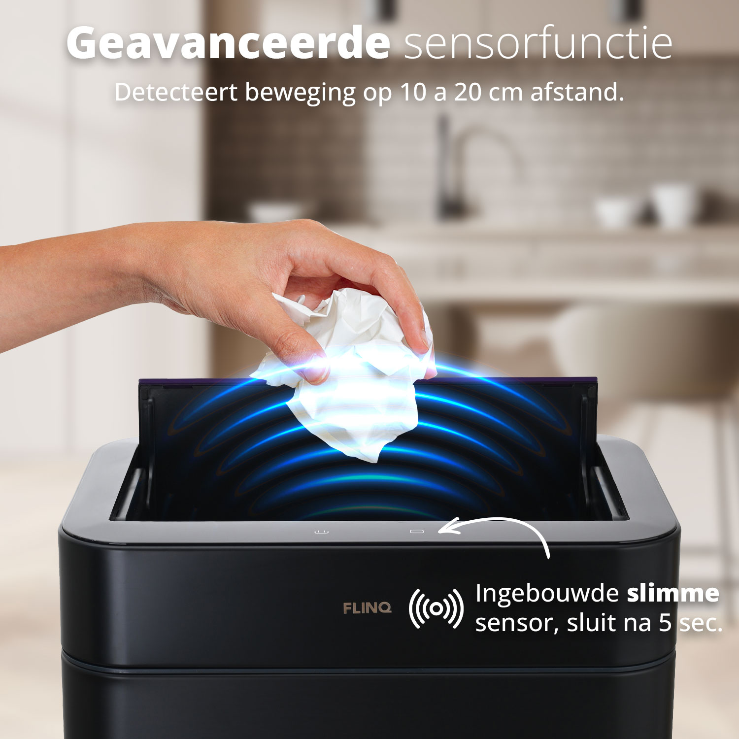 A hand is dropping a tissue into a black trash can, with a motion sensor.