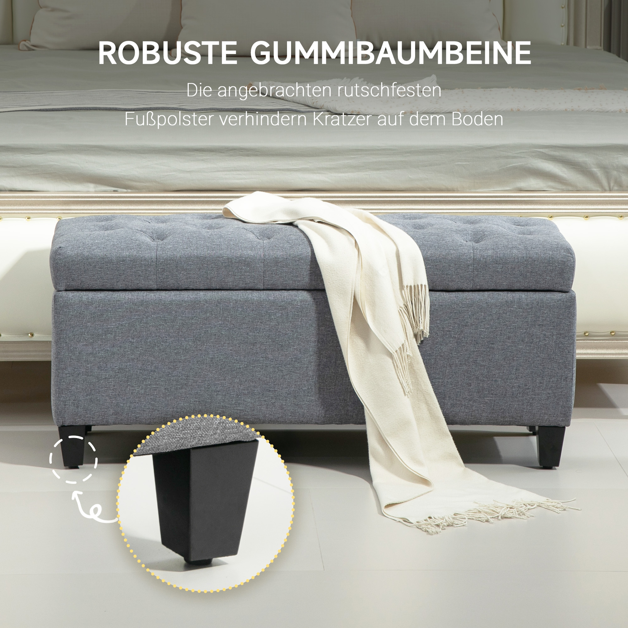 Eine graue Aufbewahrungsbank mit einer weißen Decke darauf, steht auf einem Boden, mit einem inset Bild.