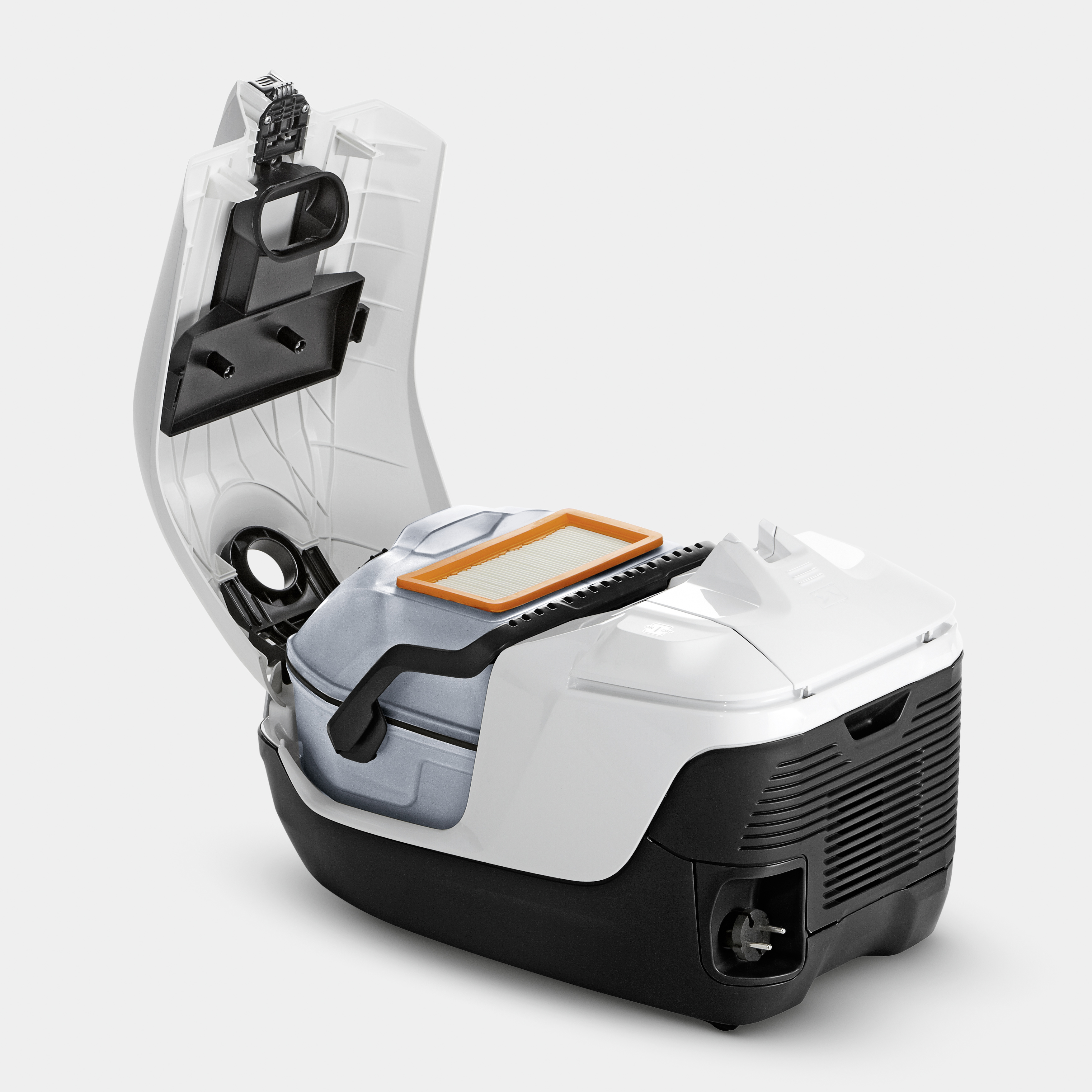 Odkurzacz, otwarty. Wewnątrz: filtr i worek na kurz. Biała obudowa, czarna podstawa. Otwarta pokrywa pokazuje elementy wewnętrzne.