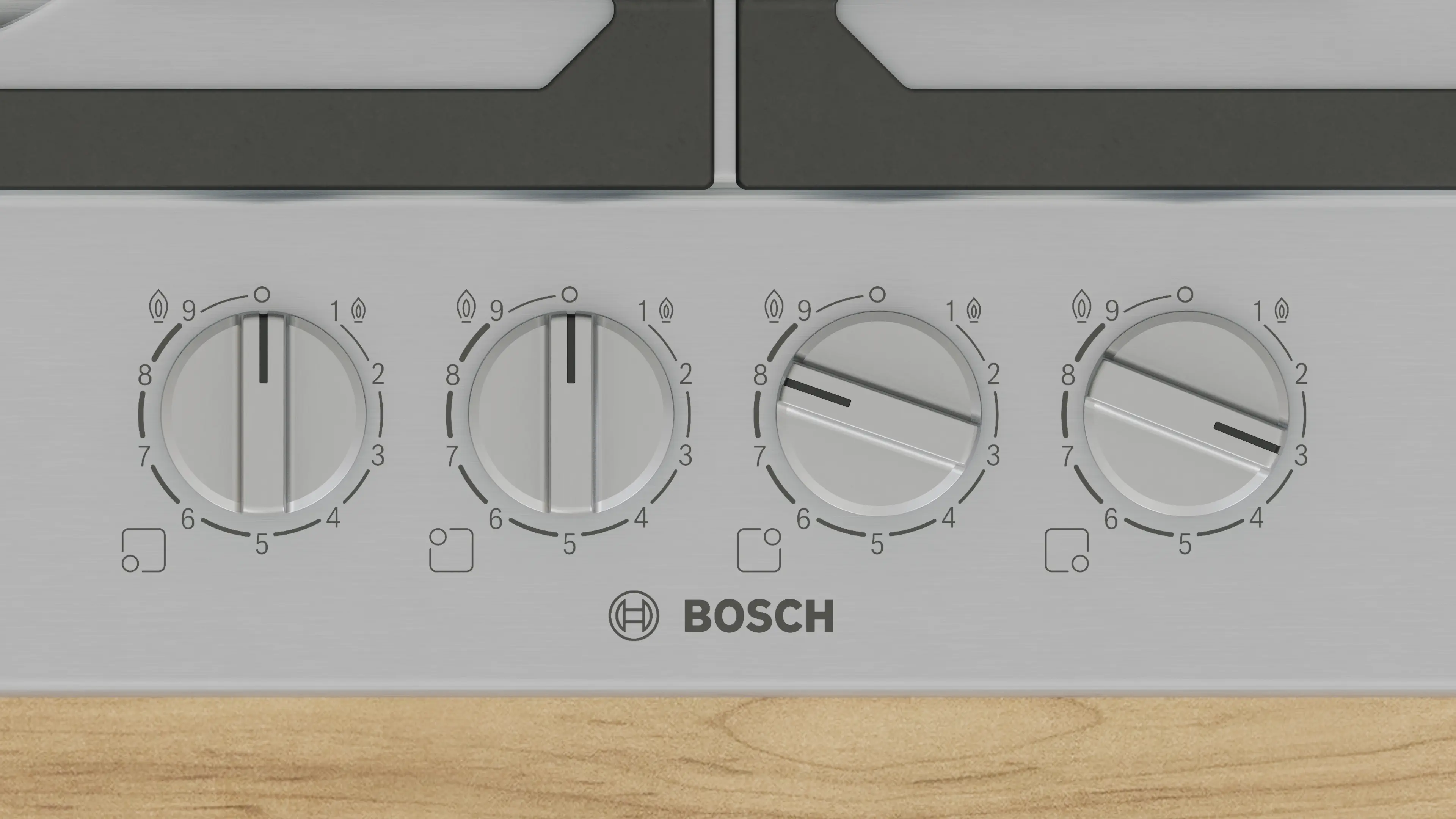 Zbliżenie pokręteł kuchenki z logo Bosch.
