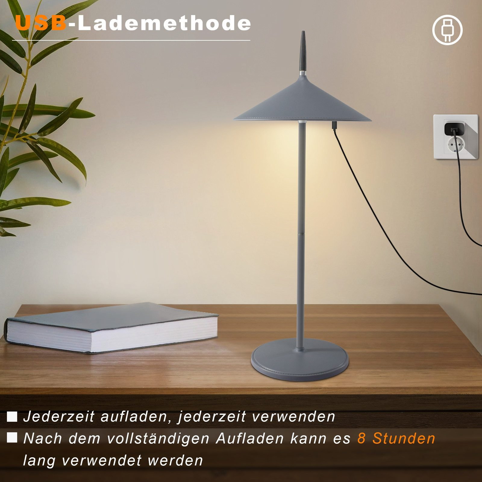 Szara lampa na drewnianym stole z książką. Widoczne jest również gniazdko i kabel ładujący.