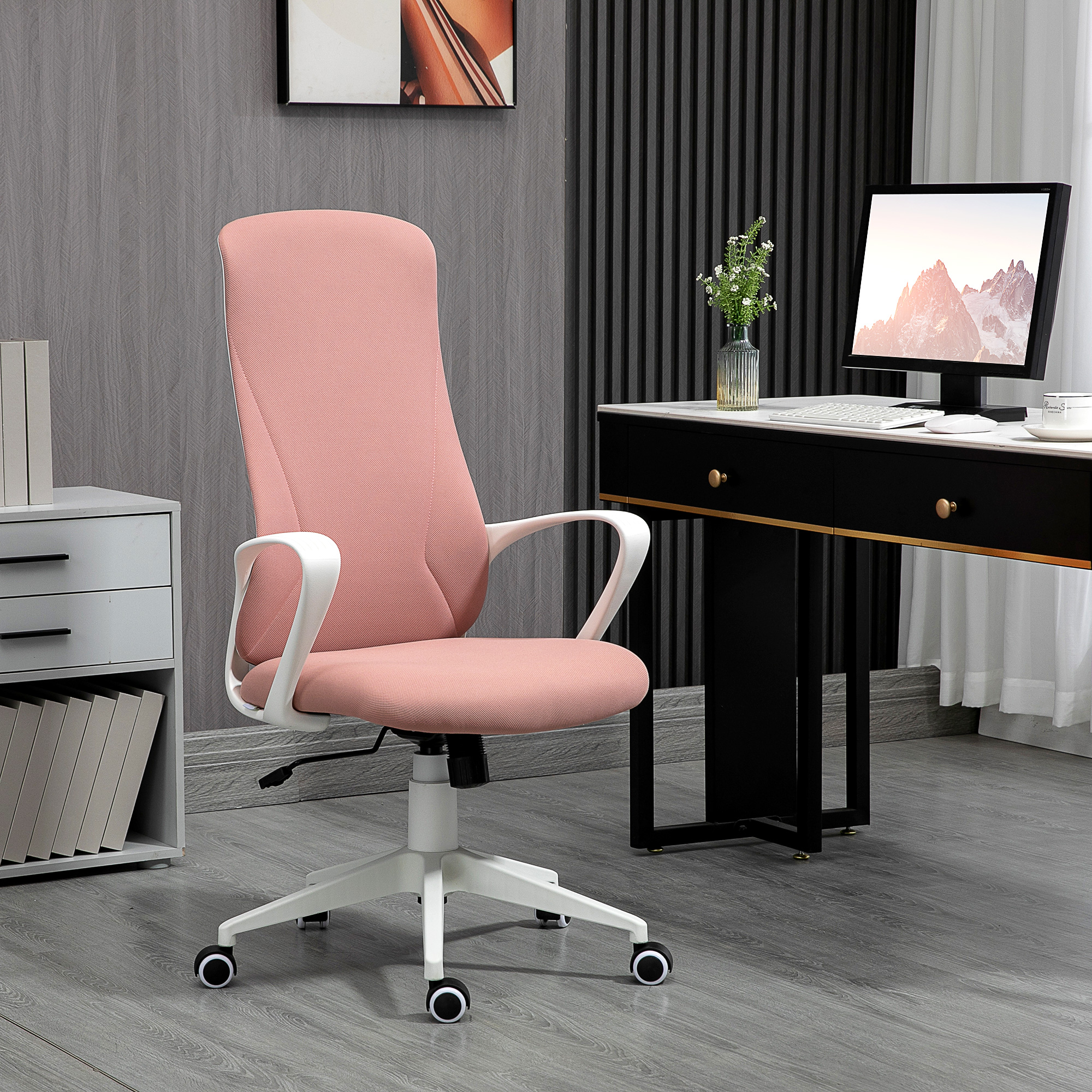 Sedia da ufficio con schienale rosa e braccioli bianchi. Scrivania con computer, libri e cassetti sullo sfondo.