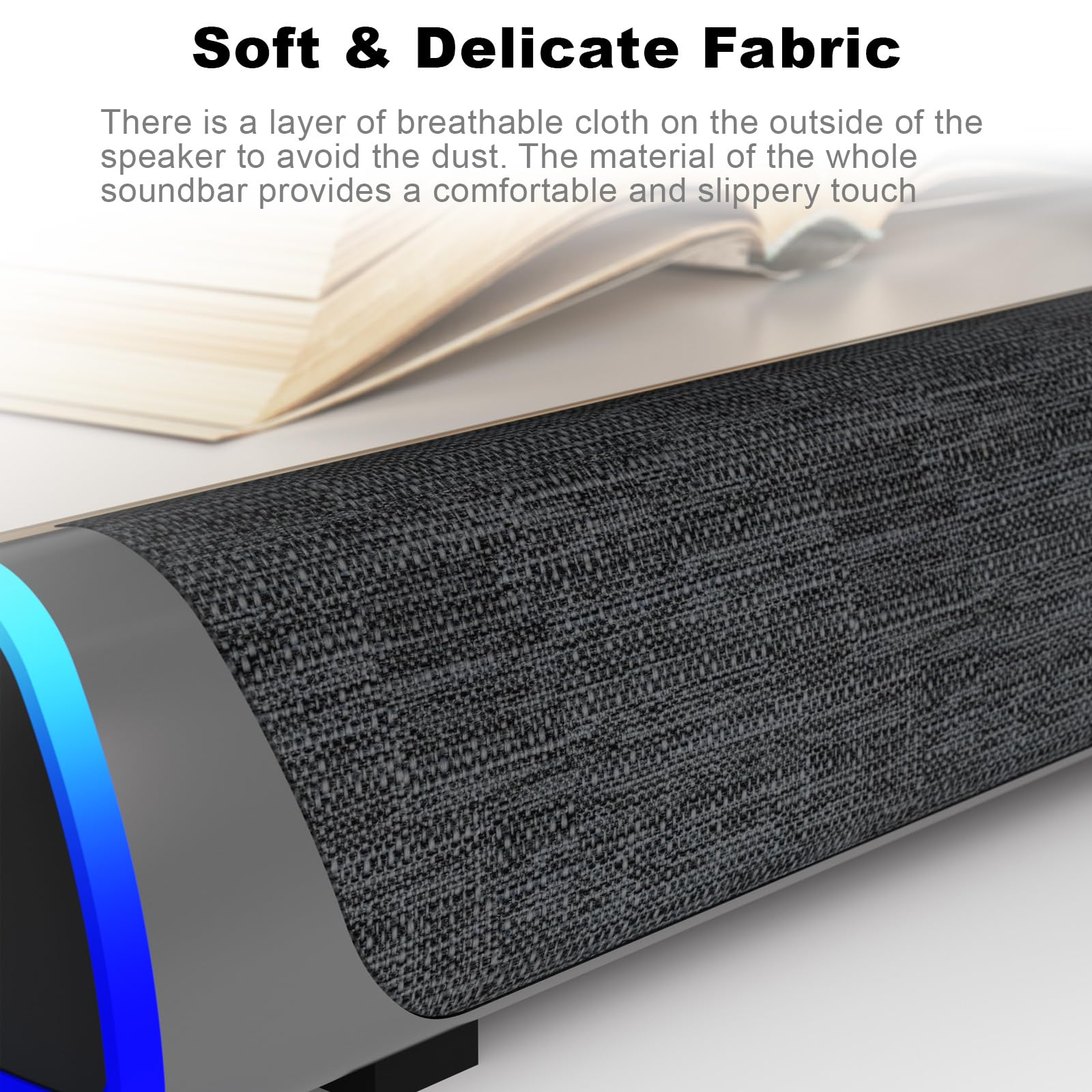 Eine Soundbar mit Stoffbezug, im Hintergrund ein Buch. Text hebt den Stoff hervor.