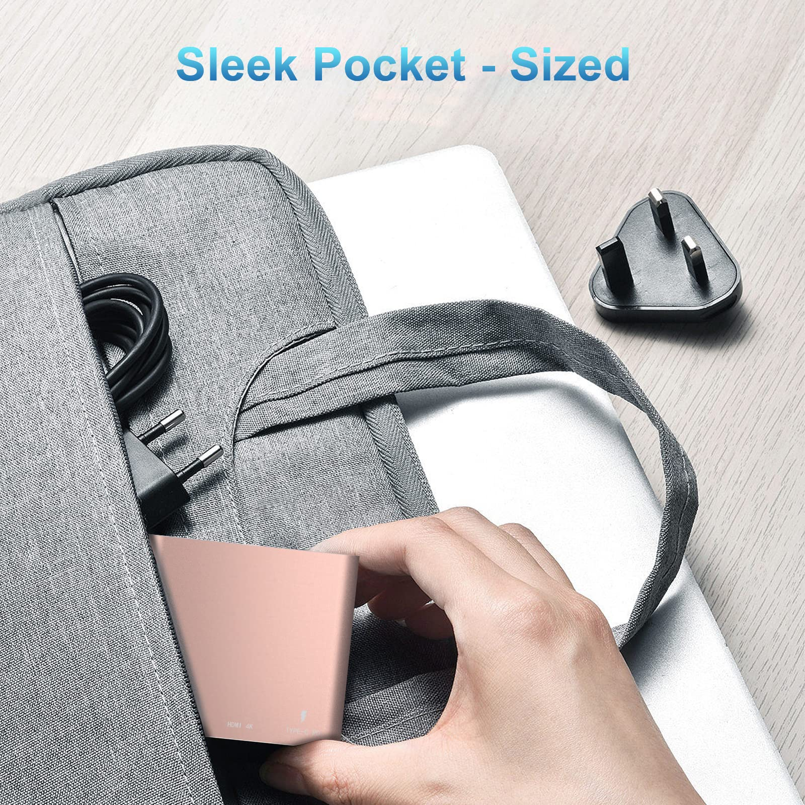 Ein roségoldener Hub in einer grauen Tasche. Ein Stecker befindet sich in der Tasche.