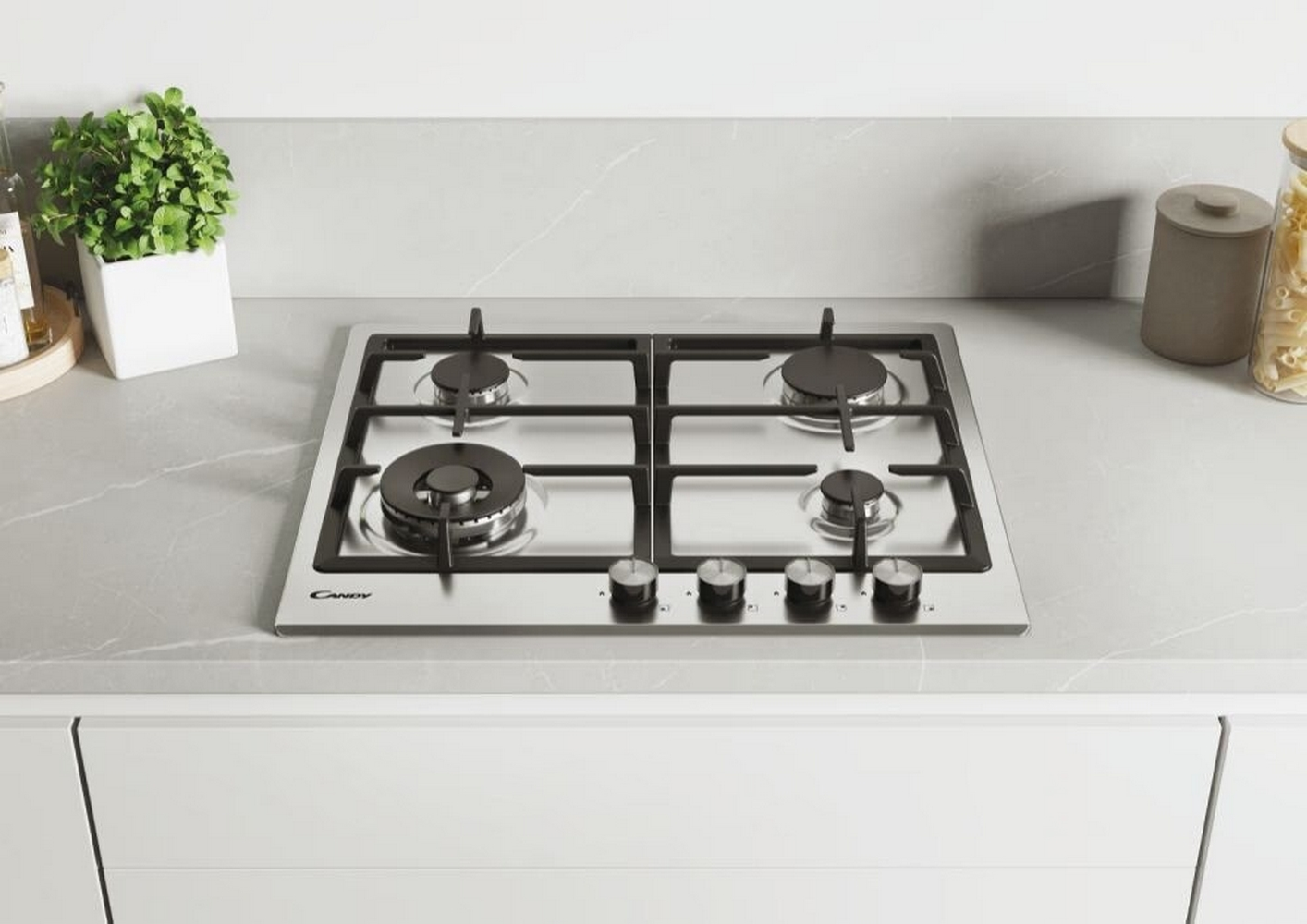 Gazowa płyta grzewcza ze stali nierdzewnej z czterema palnikami, logo Candy i pokrętłami, na blacie.