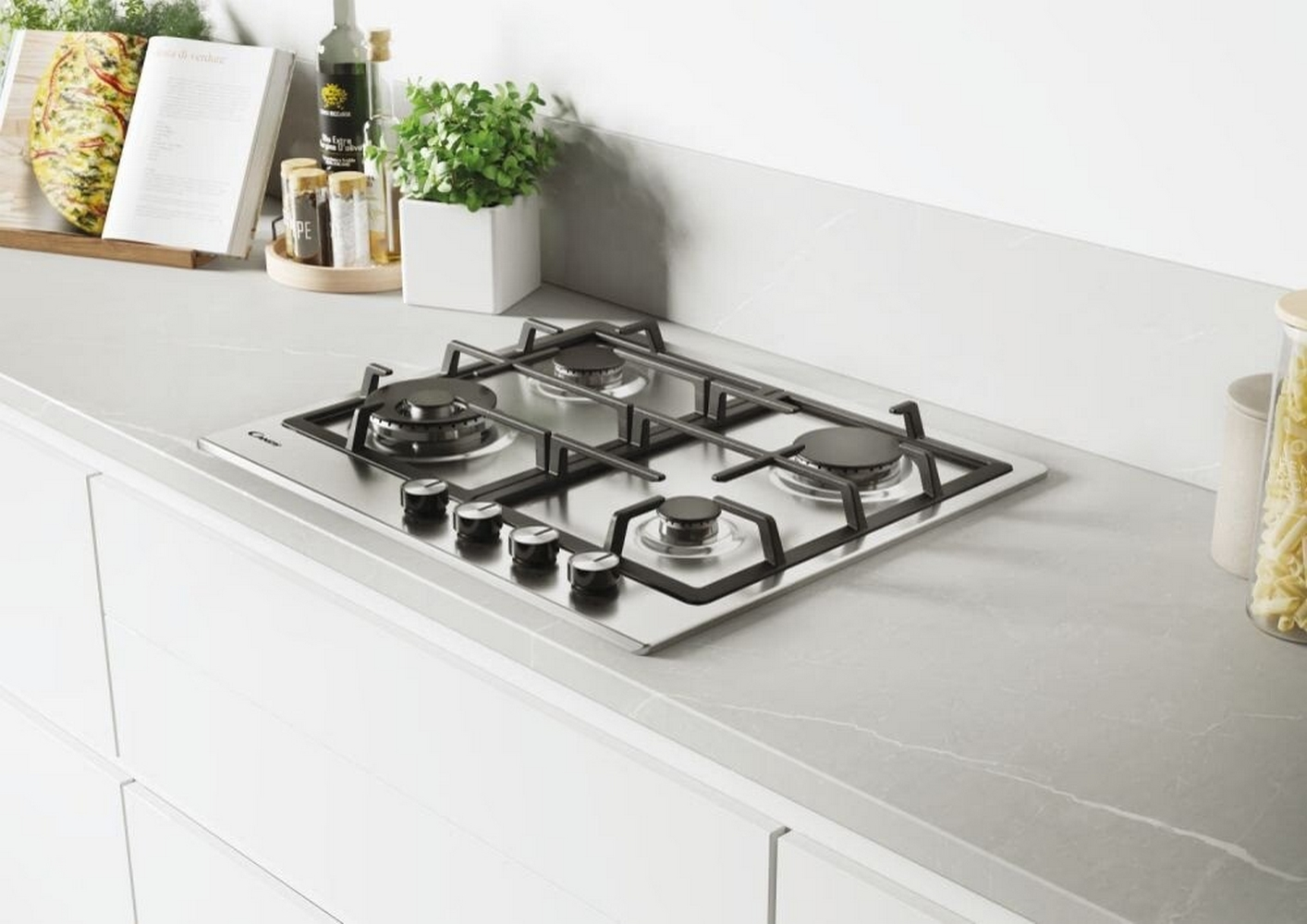 Gazowa płyta grzewcza ze stali nierdzewnej z czterema palnikami, logo Candy i pokrętłami, na blacie.