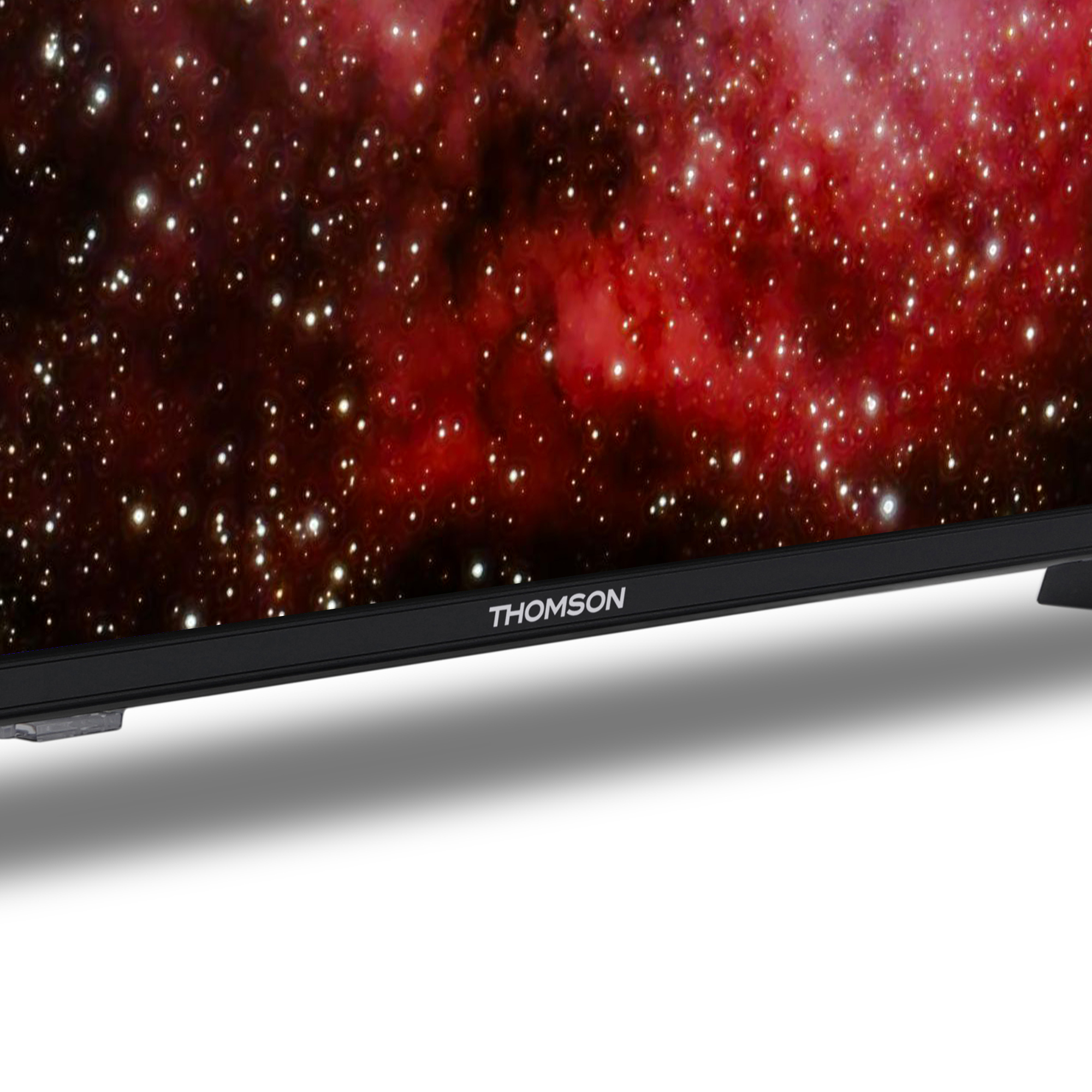 Primo piano di uno schermo TV Thomson che mostra un motivo a galassia rosso e bianco.