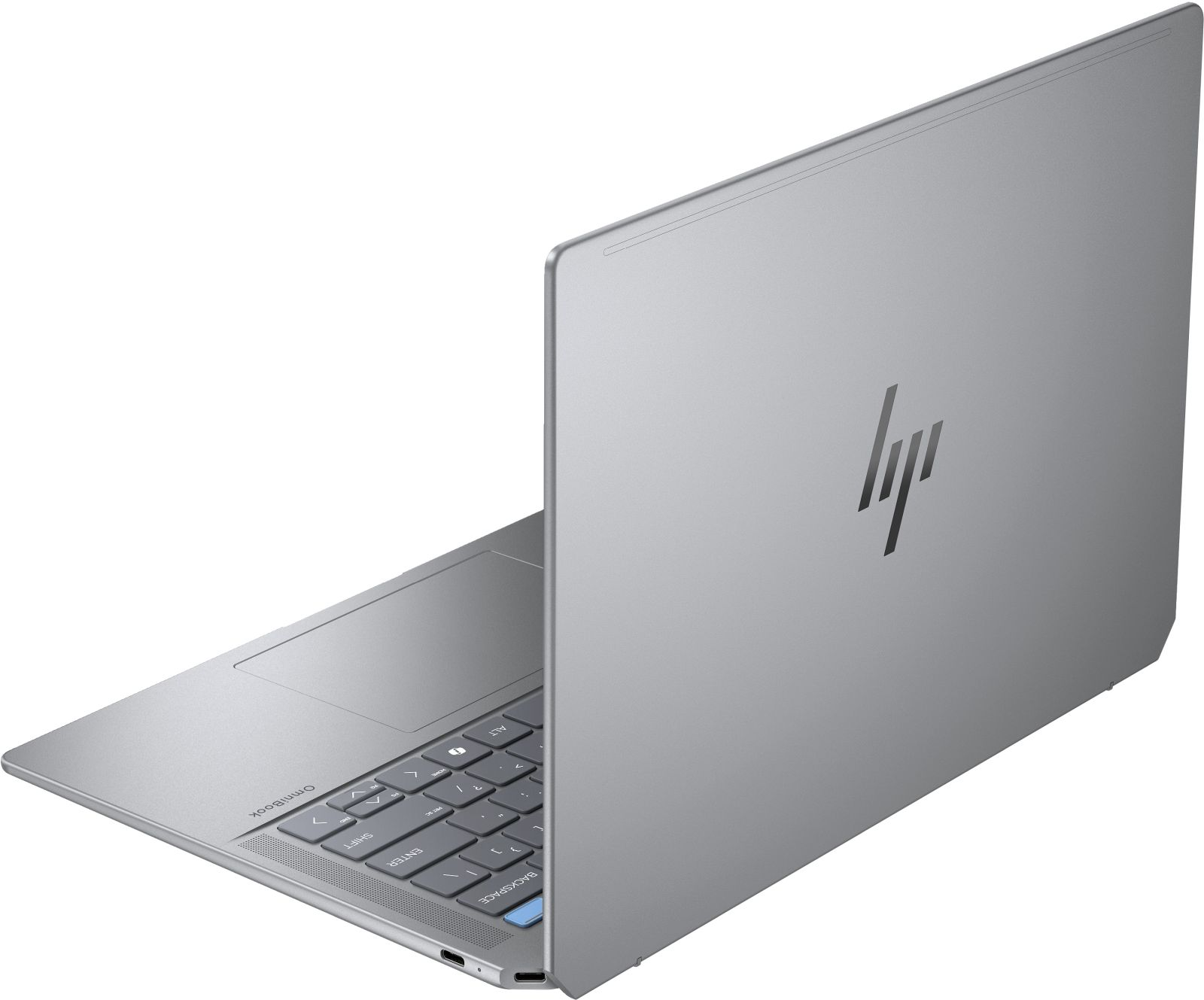 Srebrny laptop jest widziany od tyłu, z widocznym logo HP, na szarej powierzchni.
