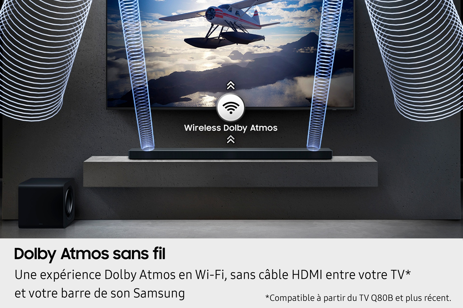 Soundbar i subwoofer z bezprzewodowym Dolby Atmos, z telewizorem w tle.