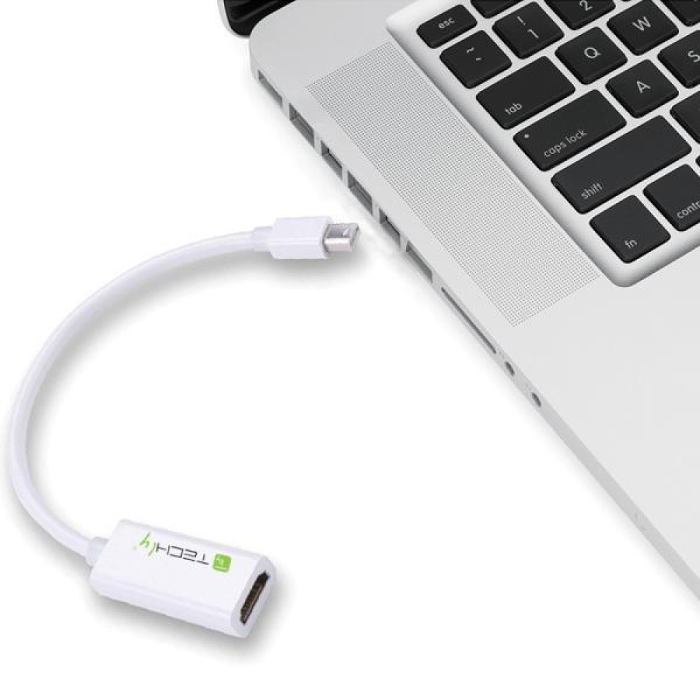 Cable adaptador blanco que conecta un portátil a una pantalla.