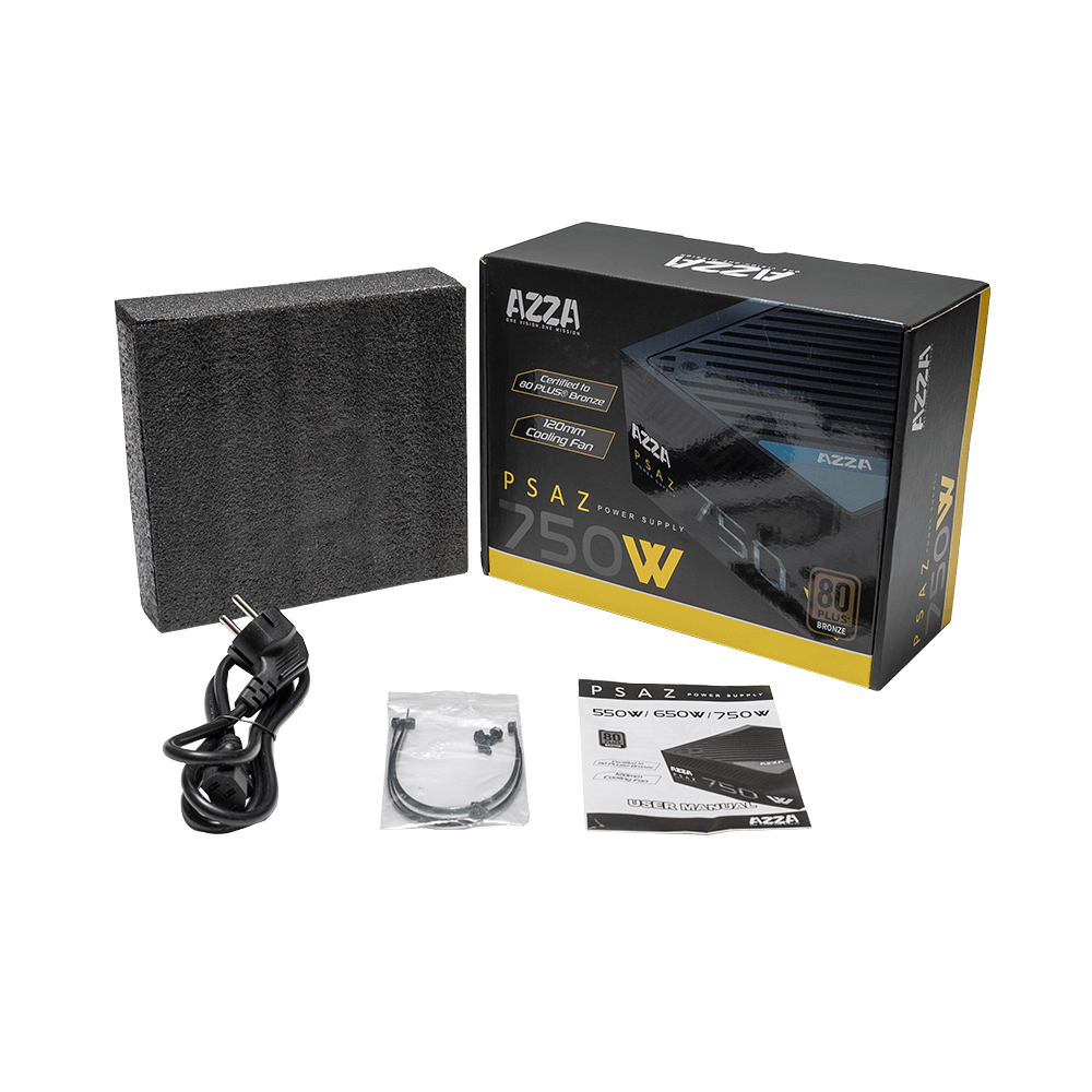 Zasilacz z pudełkiem i akcesoriami na białej powierzchni.