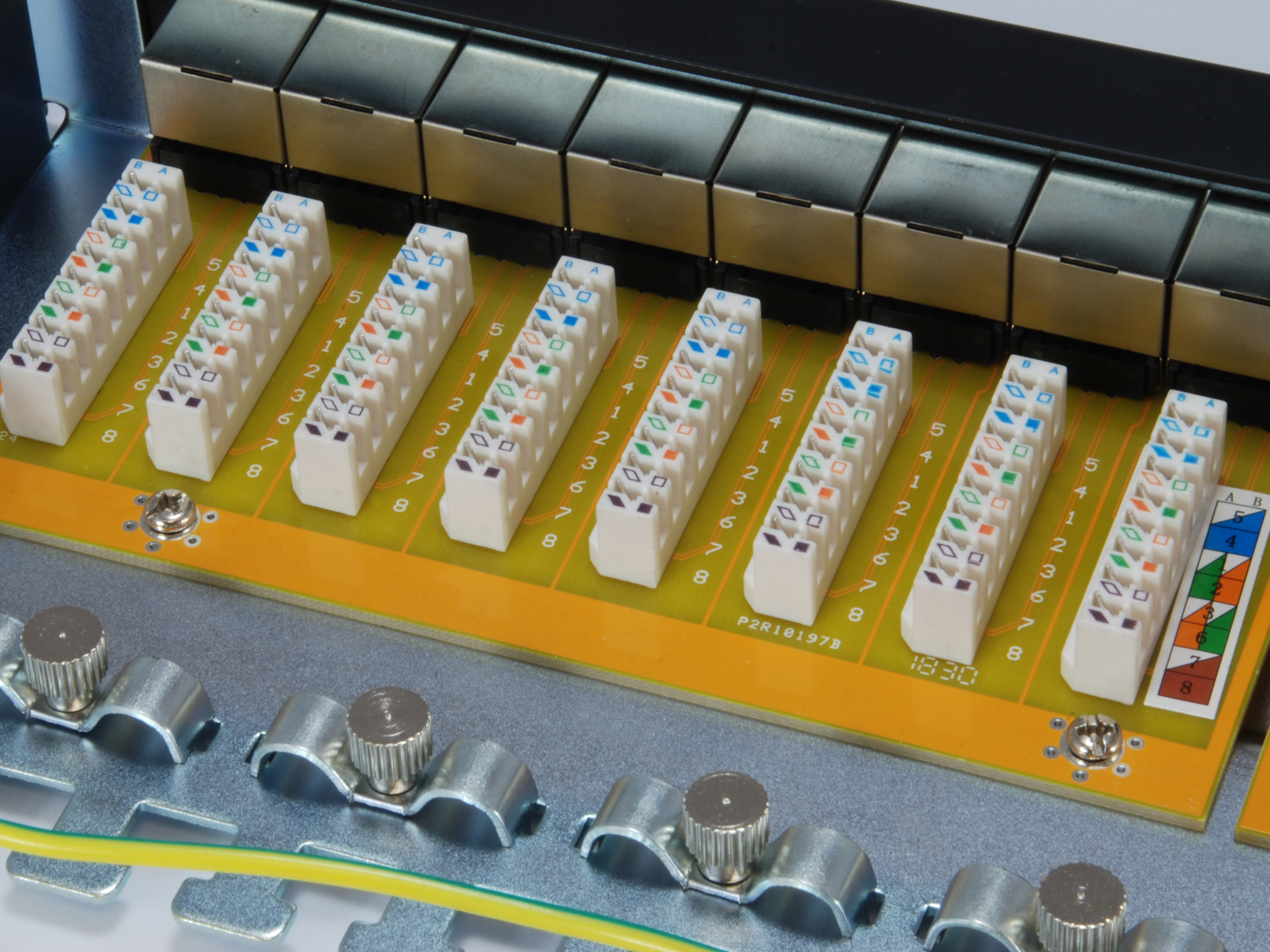 Zbliżenie na panel złącza z różnymi złączami i żółtym kablem.