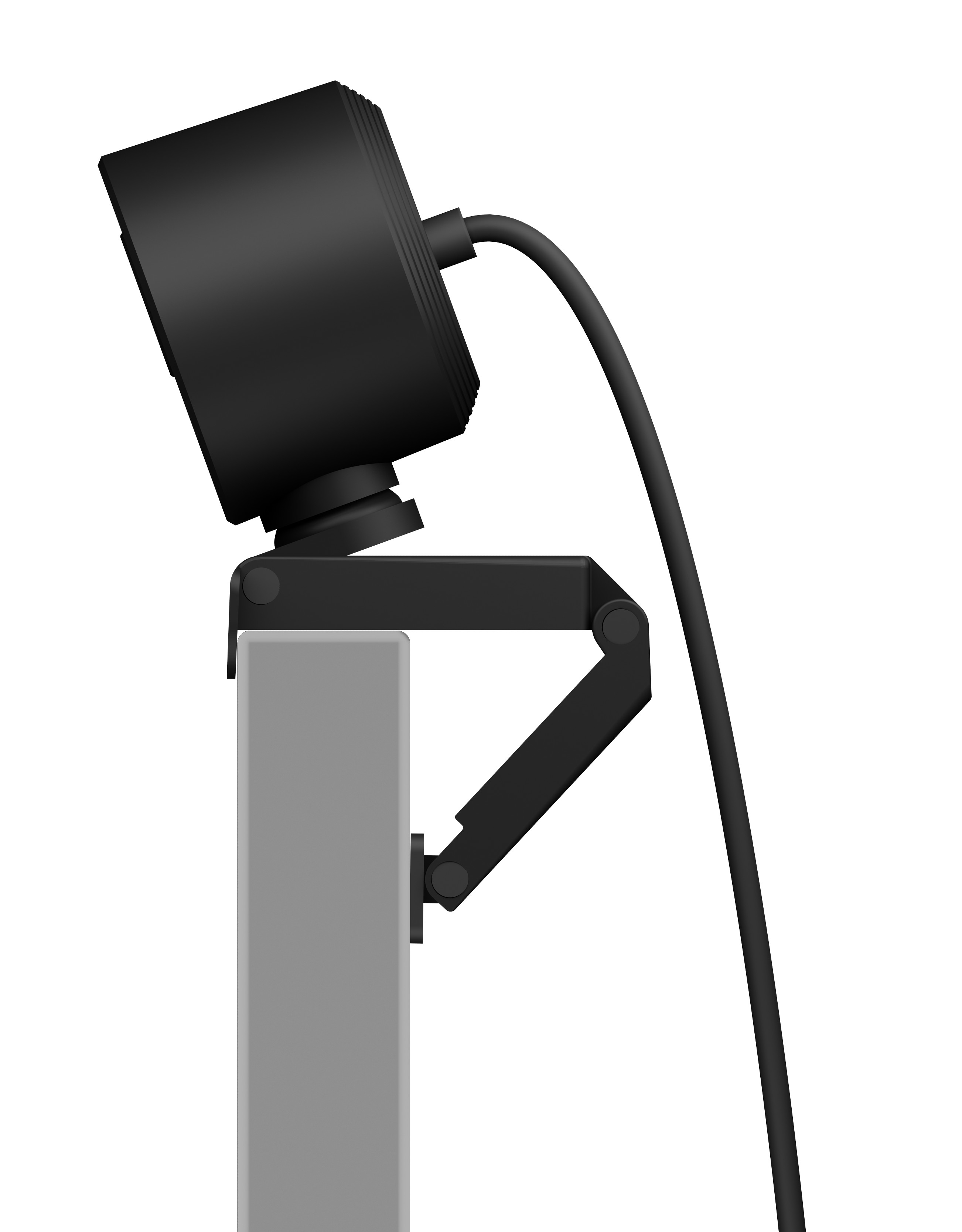 Kamera internetowa zamontowana na szarej powierzchni. Kamera jest czarna z czarnym kablem.