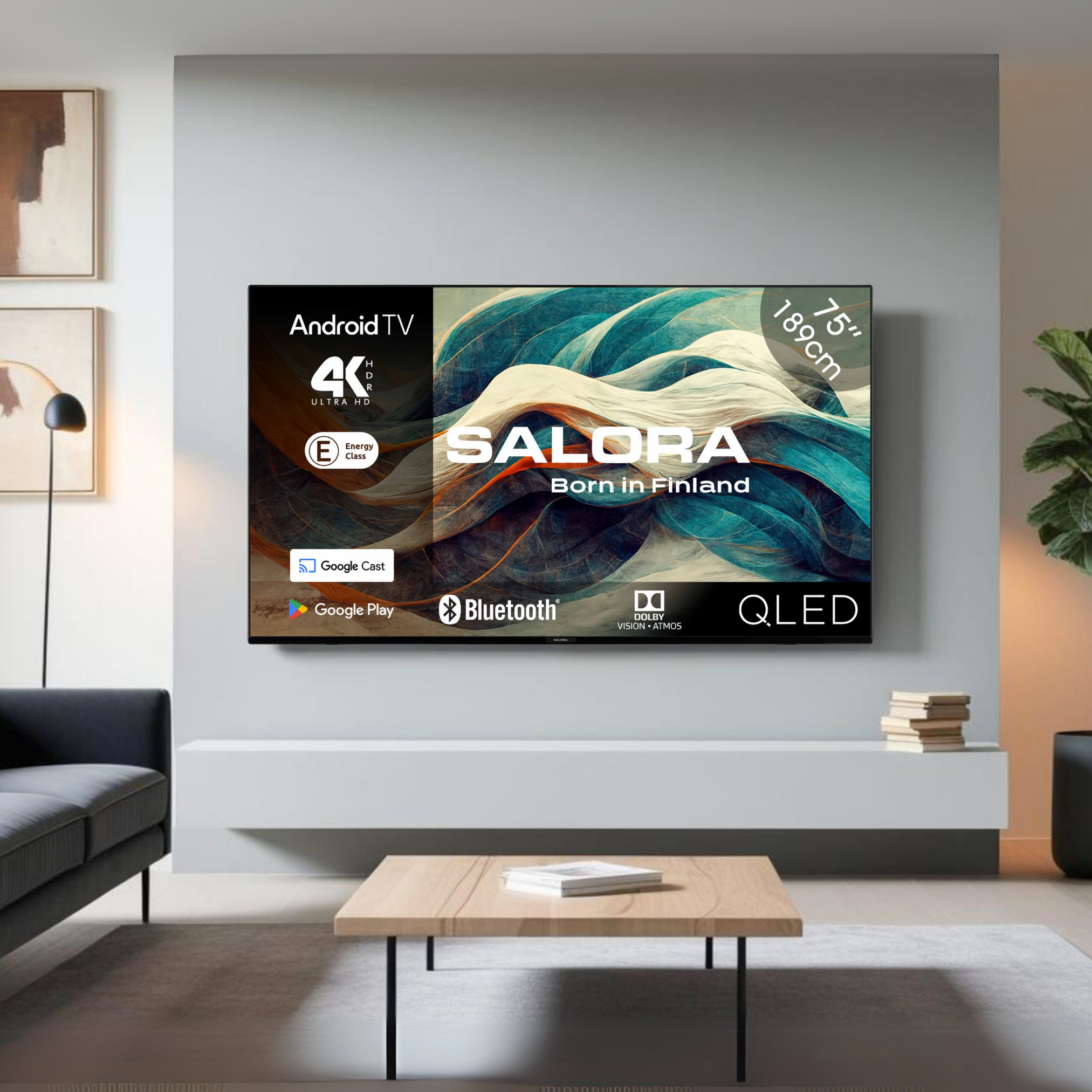 75" Salora Android TV. The screen displays abstract artwork. A sofa, table, and plant are in the scene.