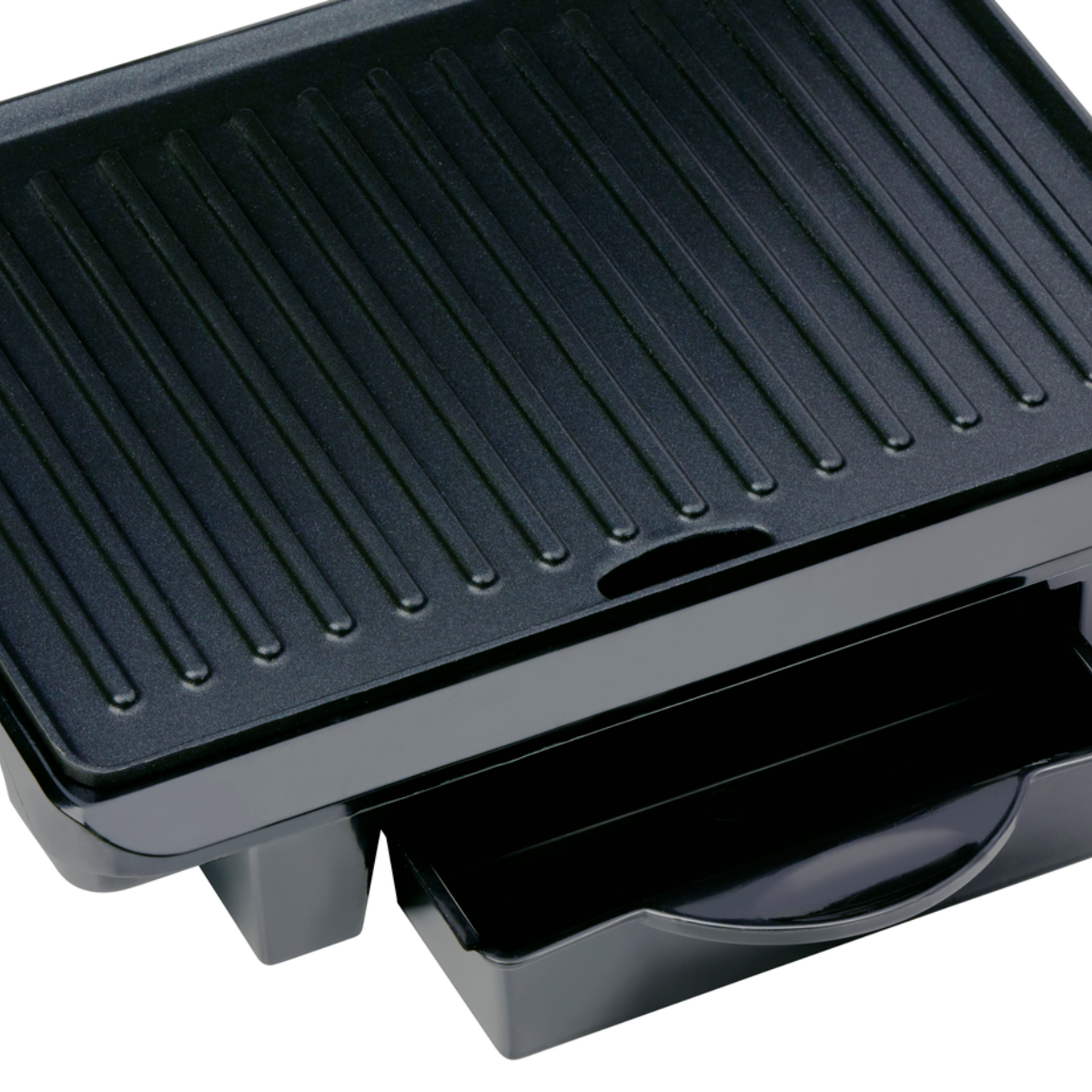 Close-up of a black grill with a drawer, showing the grilling surface.