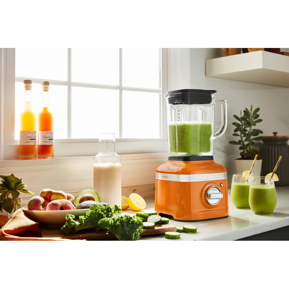 Kitchen scene with an orange blender. There are ingredients, a window, and drinks. Sunny, bright lighting.