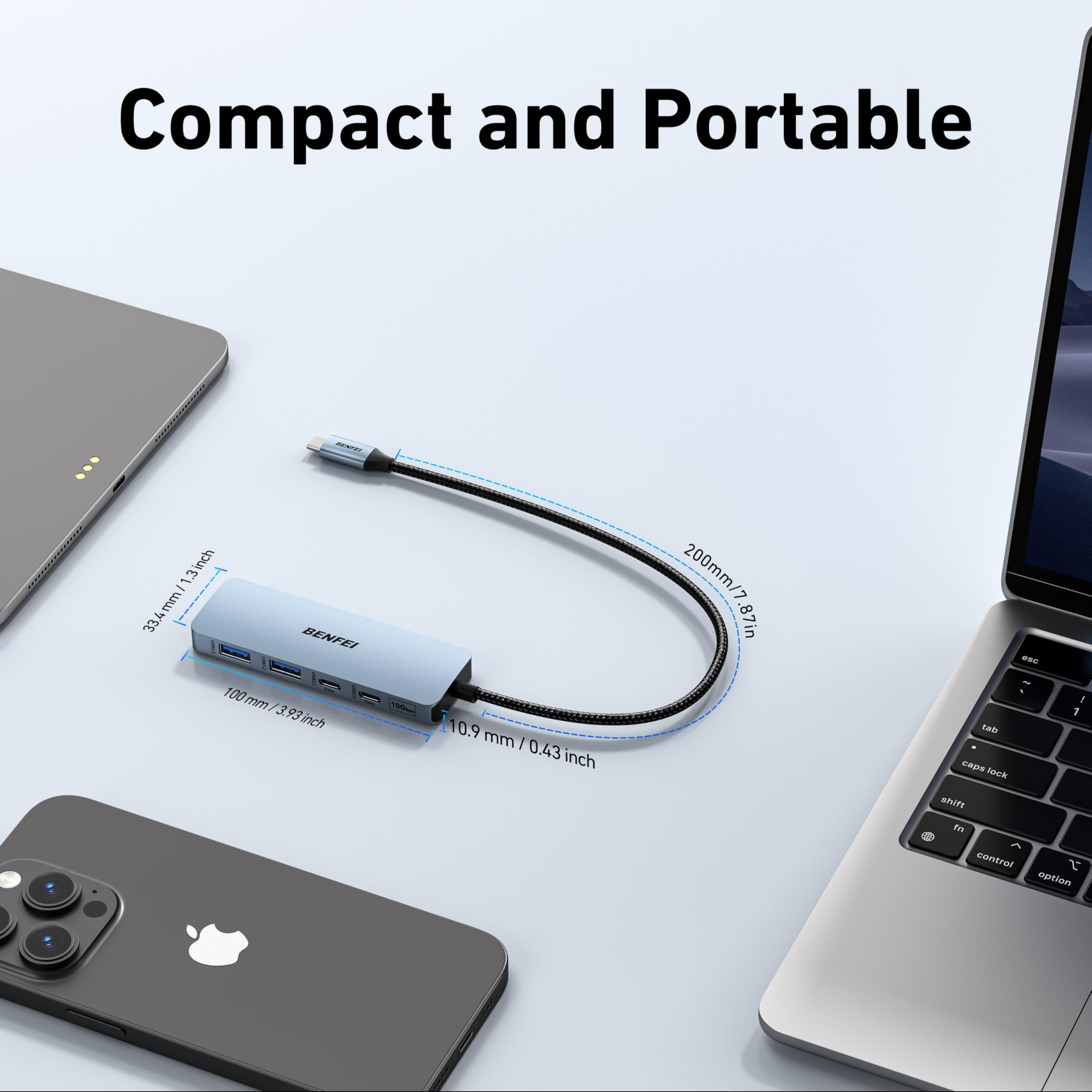 USB-C-Hub mit Kabeln, umgeben von Telefon und Laptop.