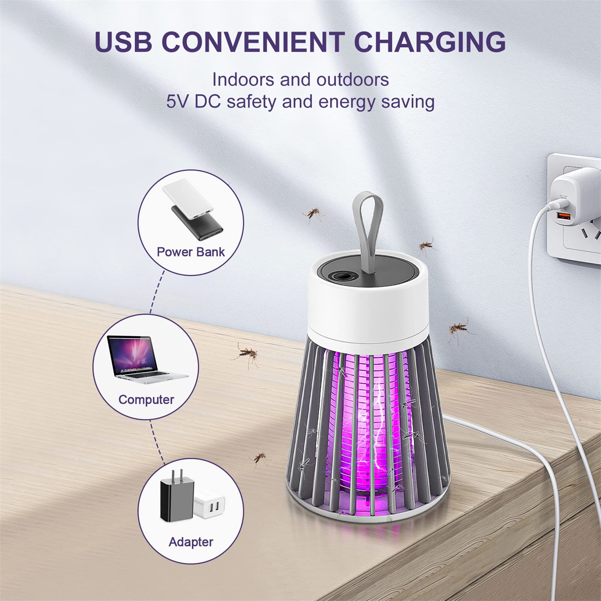 Insektenfalle mit lila Licht, in der Nähe einer Powerbank, eines Laptops und eines Adapters, USB-Laden.