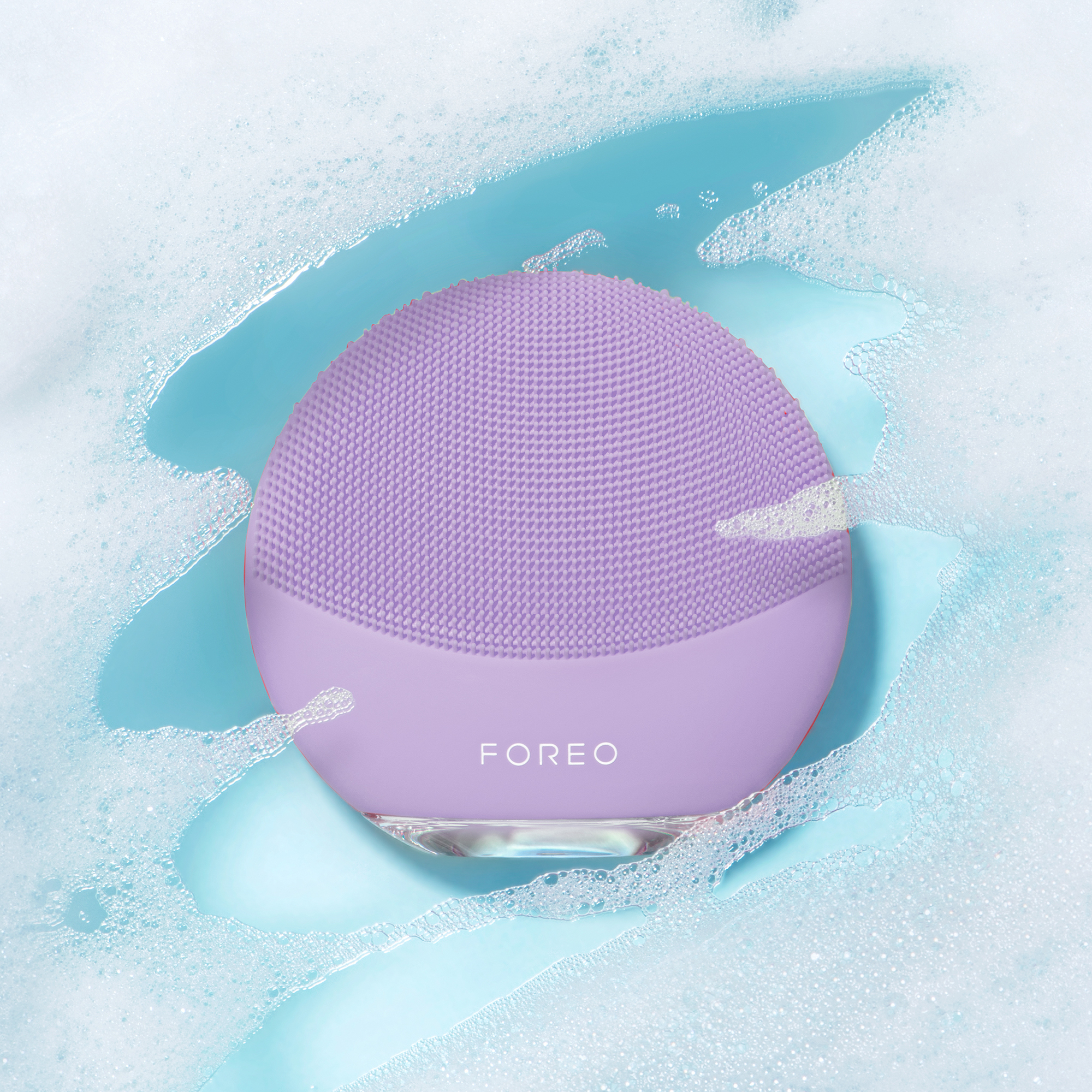 Face cleaner in water. The product is in focus in a light blue water environment.