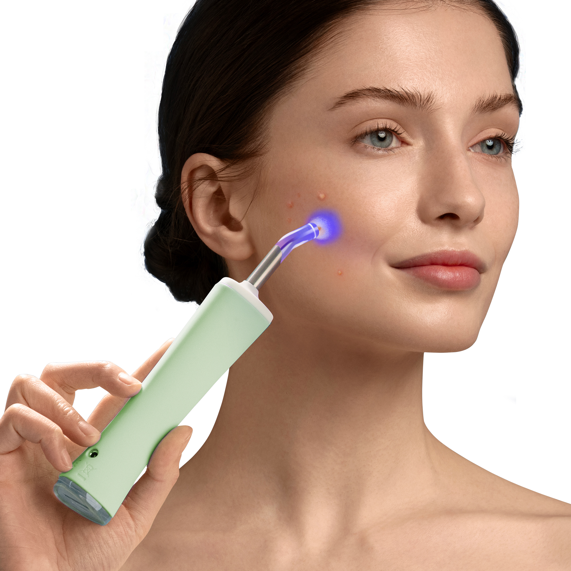 Woman using a green device on her face. Device emits blue light. White background.