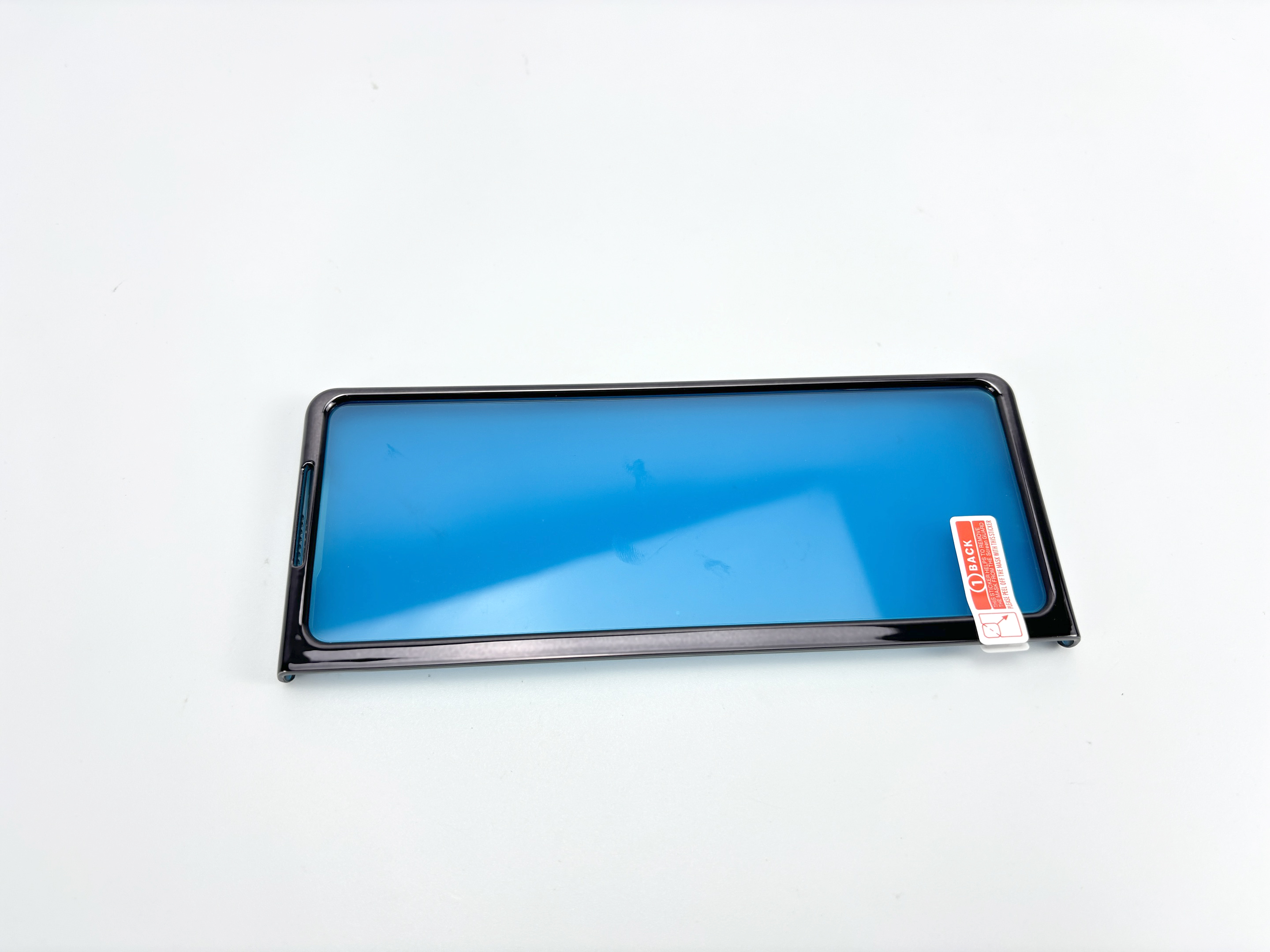 Un proteggi schermo per telefono con una tinta blu, in una custodia, su sfondo bianco.