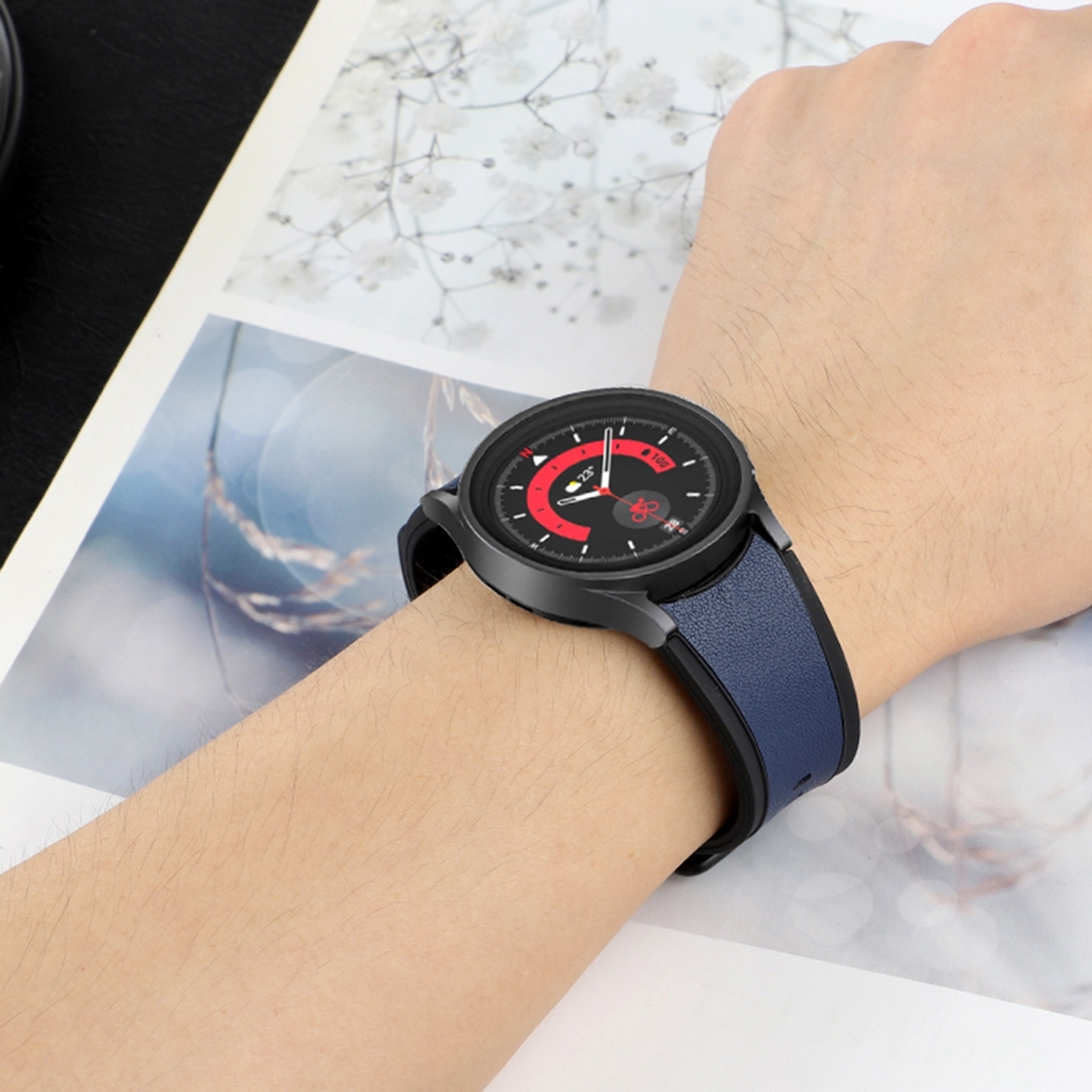 Mann trägt Smartwatch mit blauem Armband. Zifferblatt zeigt Zeit und Herzfrequenz.