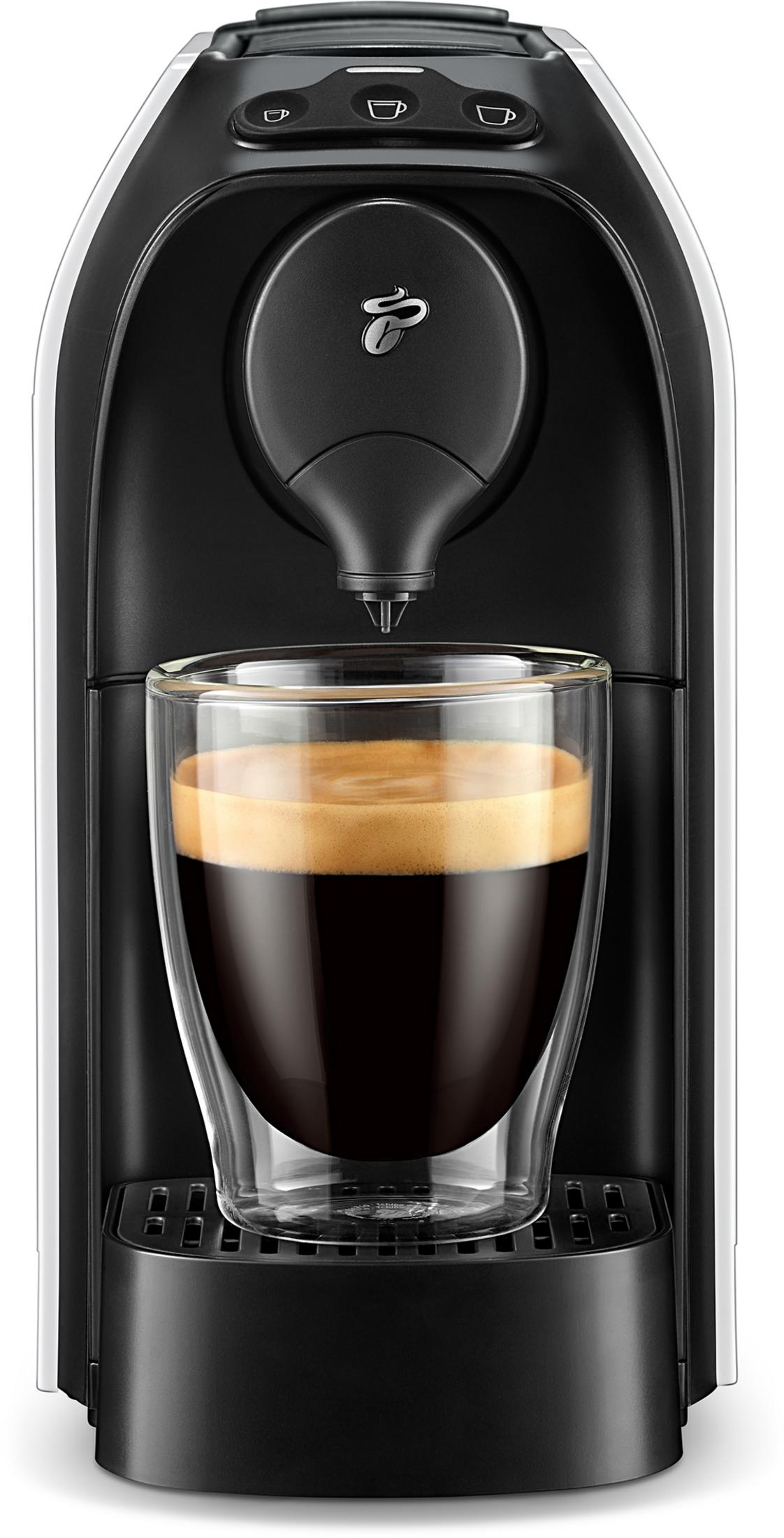 Kaffeemaschine mit einem Glas Kaffee. Die Maschine ist weiß und schwarz.
