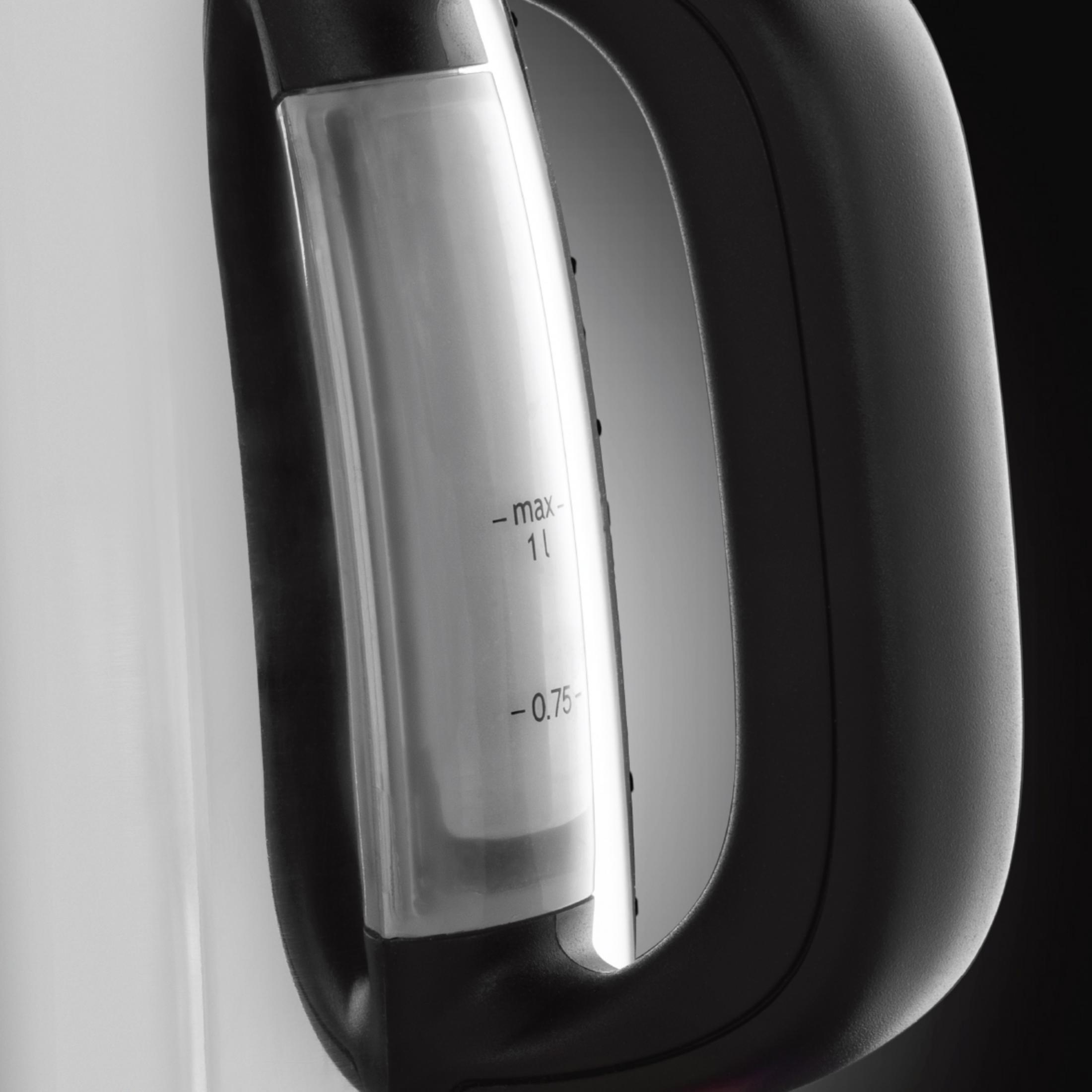 Zbliżenie wskaźnika poziomu wody na białym i czarnym czajniku.