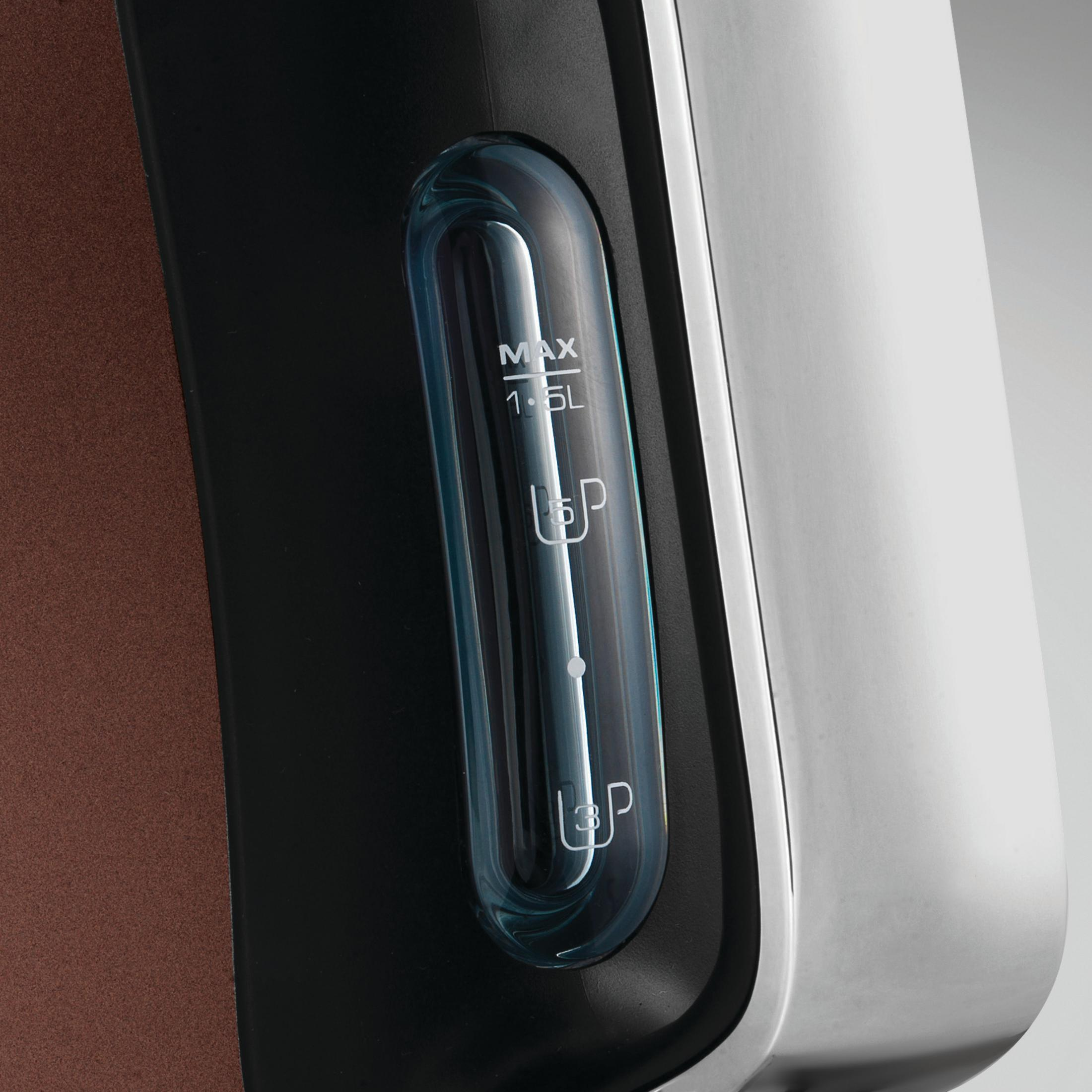 Zbliżenie czajnika ze wskaźnikiem poziomu wody. Wskaźnik pokazuje poziomy. Brązowy i srebrny.