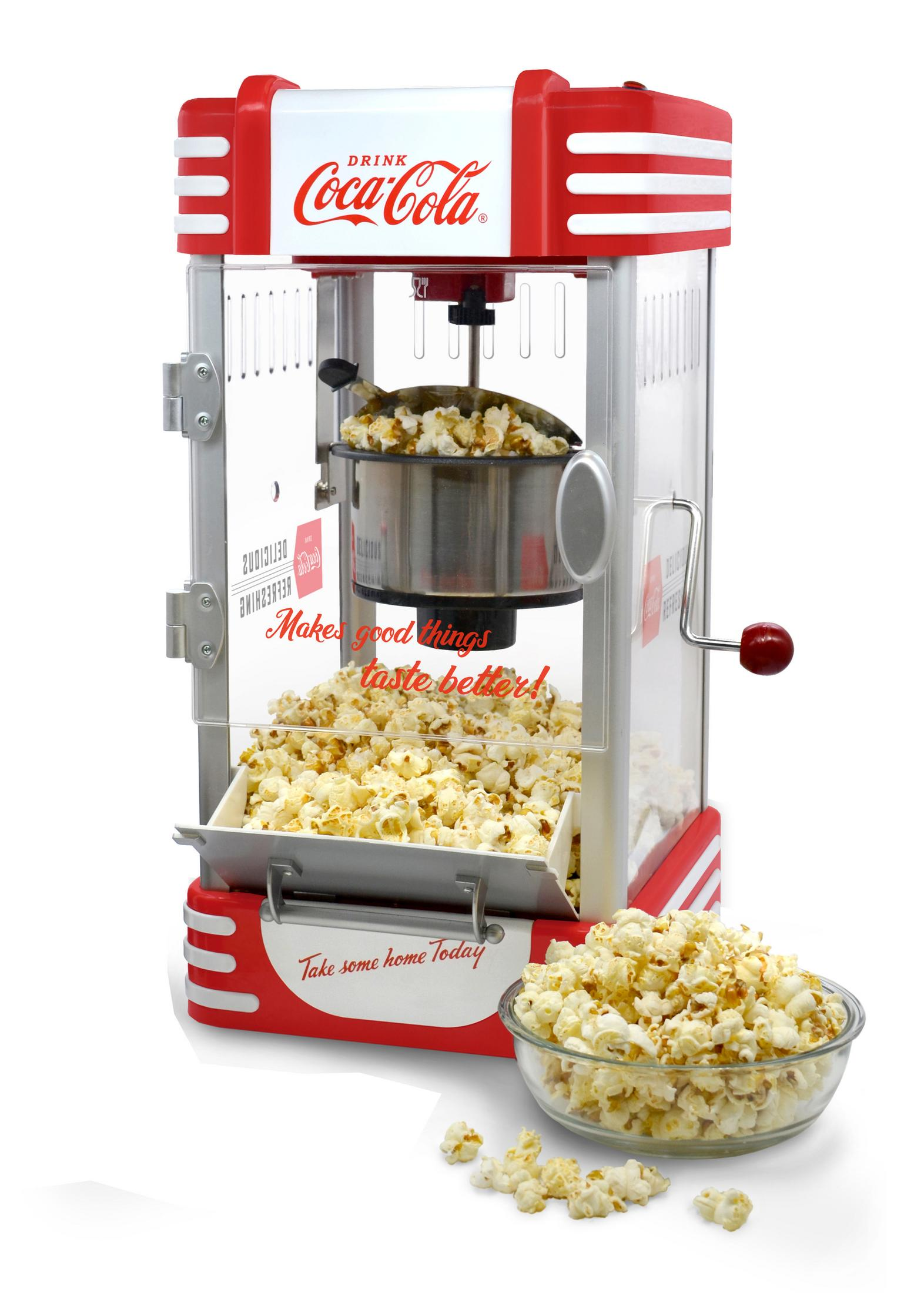 Eine Coca-Cola Popcornmaschine mit Popcorn, rot-weißem Design und einer Glasschüssel.